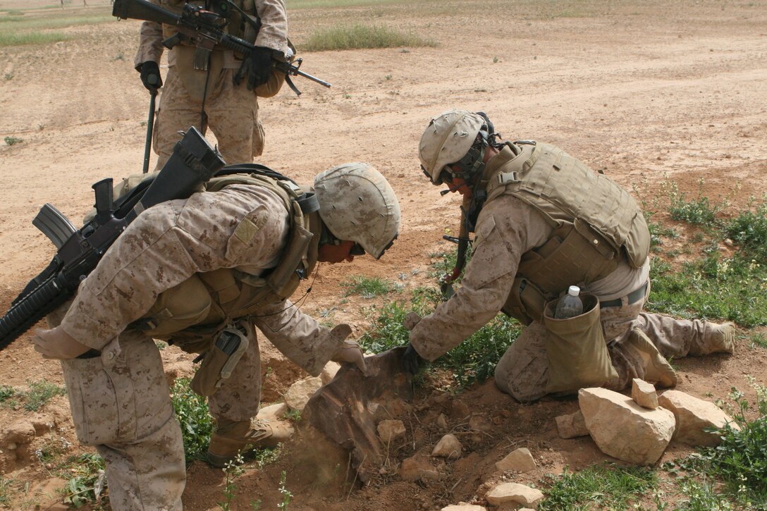 Marines of 1st Combat Engineer Battalion dig through debris in search of any weapons caches.  The Marines conducted cache sweeps from March 12-16.