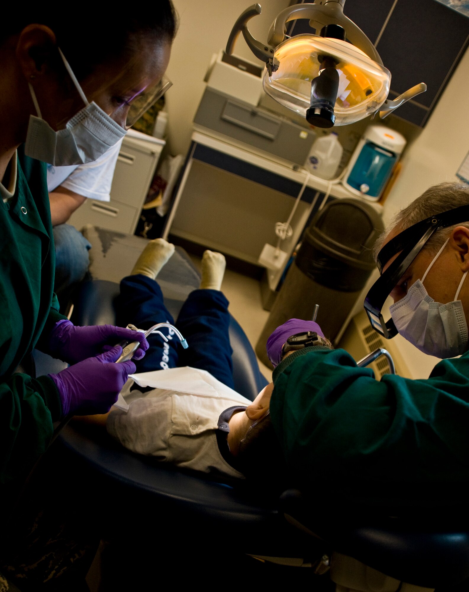 Tech. Sgt. Kristie Subieta, a dental hygenist, and Navy Capt. Doug Henschel, a dentist, provide fillings for Dylon Sergie, 2, at a health clinic in Kwethluk, Alaska, on March 10, 2009.  A joint military medical team is deployed to Kwethluk, a small village in Western Alaska, in support of Operation Arctic Care. This year's Navy-led mission has teams in 11 villages in Alaska's Yukon-Kuskokwim Delta region providing medical, dental and veterinary support at no cost to Alaskan natives. (U.S. Air Force photo by Senior Airman Christopher Griffin)