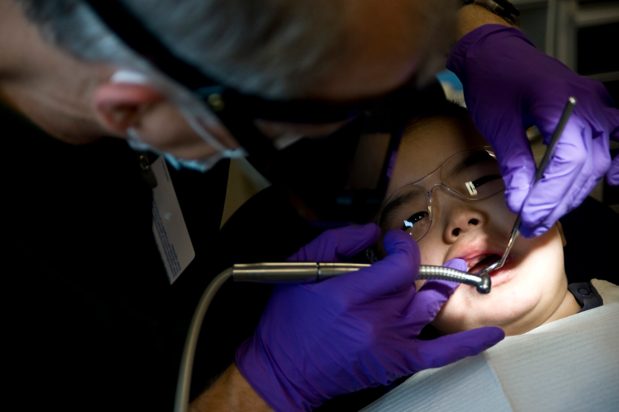 Navy Capt. Doug Henschel, a dentist assigned to the 14th Dental Company, inserts a filling for Dylon Sergie, 2, at a health clinic in Kwethluk, Alaska, on March 10, 2009. A joint military medical team is deployed to Kwethluk, a small village in Western Alaska, in support of Operation Arctic Care. This year's Navy-led mission has teams in 11 villages in Alaska's Yukon-Kuskokwim Delta region providing medical, dental and veterinary support at no cost to Alaskan natives. (U.S. Air Force photo by Senior Airman Christopher Griffin)