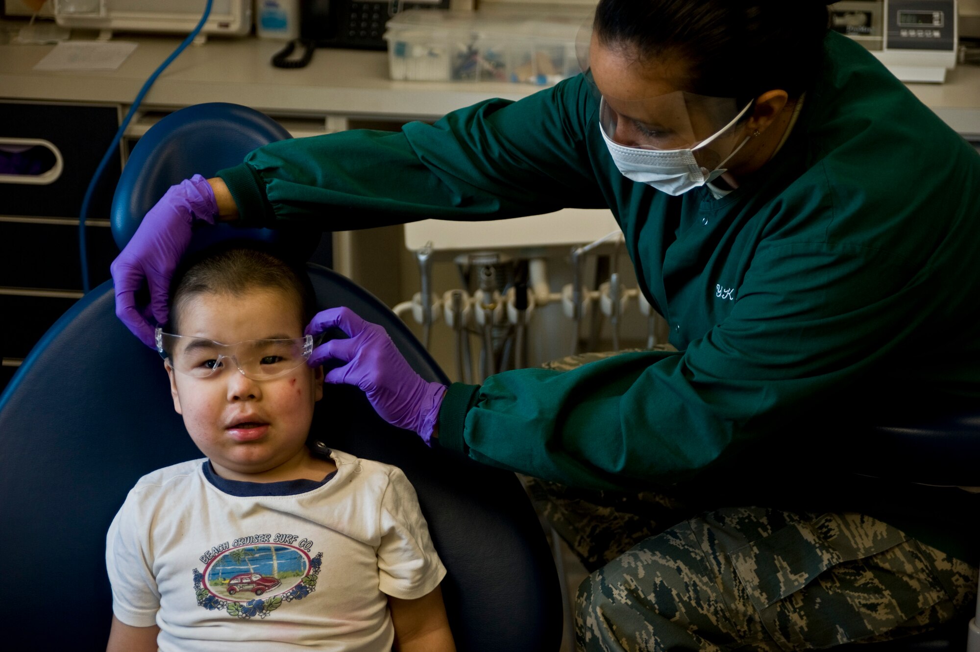 Tech. Sgt. Kristie Subieta, a dental hygenist assigned to the 507th Medical Squadron at Tinker Air Force Base, adjusts protective eye glasses on Dylon Sergie, 2, at a health clinic in Kwethluk, Alaska, on March 10, 2009. A joint military medical team is deployed to Kwethluk, a small village in Western Alaska, in support of Operation Arctic Care. This year's Navy-led mission has teams in 11 villages in Alaska's Yukon-Kuskokwim Delta region providing medical, dental and veterinary support at no cost to Alaskan natives. (U.S. Air Force photo by Senior Airman Christopher Griffin)