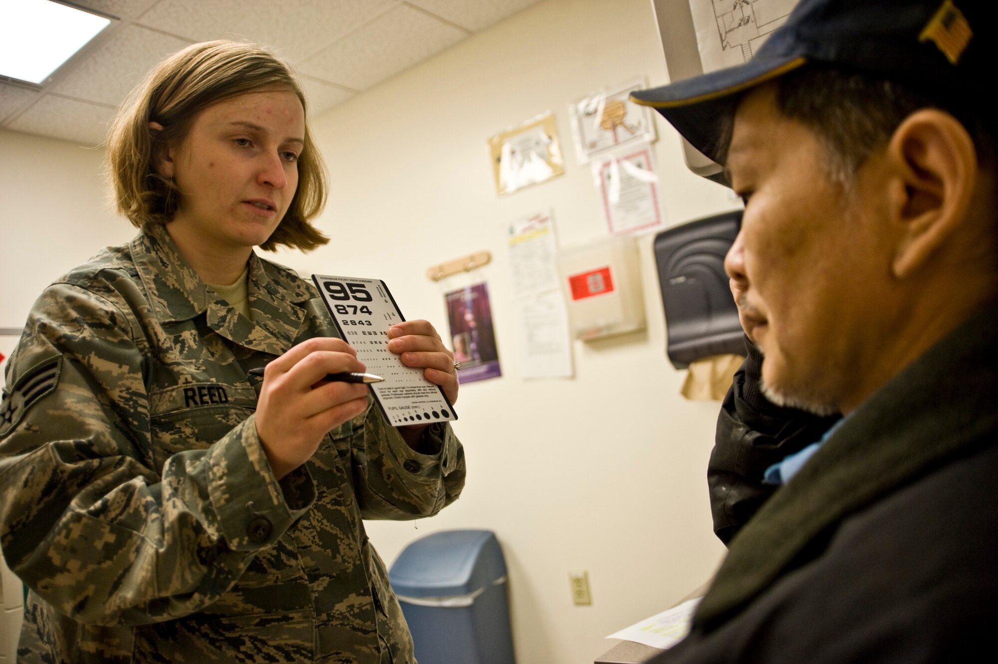 Senior Airman Samantha Reed, a optometry technician at McConnell Air Force Base, conducts an eye examination on a patient at a health clinic in Kwethluk, Alaska, on March 10, 2009. A joint military medical team is deployed to Kwethluk, a small village in Western Alaska, in support of Operation Arctic Care. This year's Navy-led mission has teams in 11 villages in Alaska's Yukon-Kuskokwim Delta region providing medical, dental and veterinary support at no cost to Alaskan natives. (U.S. Air Force photo by Senior Airman Christopher Griffin)
