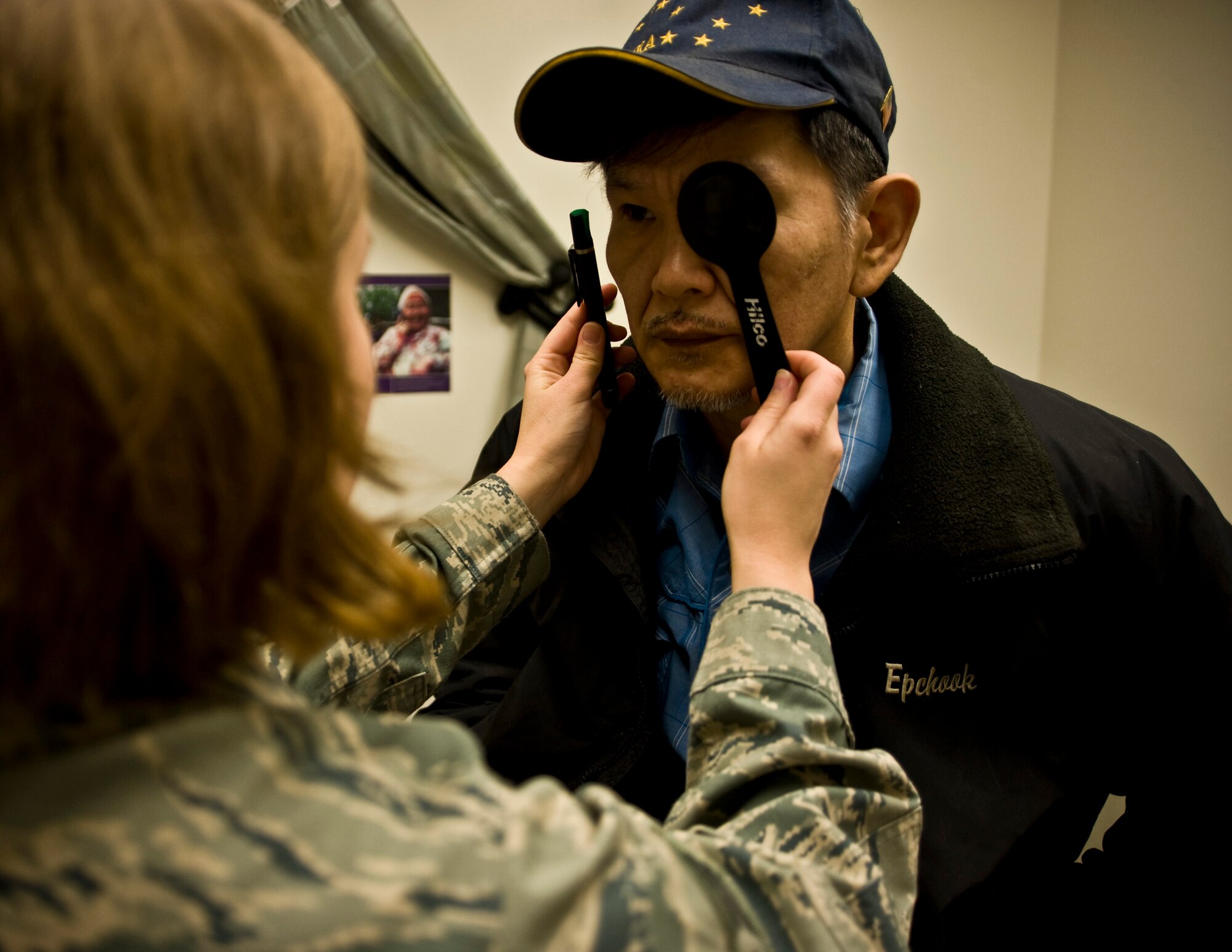Senior Airman Samantha Reed, an optometry technician at McConnell Air Force Base, tests a patient's peripheral vision at a health clinic in Kwethluk, Alaska, on March 10, 2009. A joint military medical team is deployed to Kwethluk, a small village in Western Alaska, in support of Operation Arctic Care. This year's Navy-led mission has teams in 11 villages in Alaska's Yukon-Kuskokwim Delta region providing medical, dental and veterinary support at no cost to Alaskan natives. (U.S. Air Force photo by Senior Airman Christopher Griffin) 