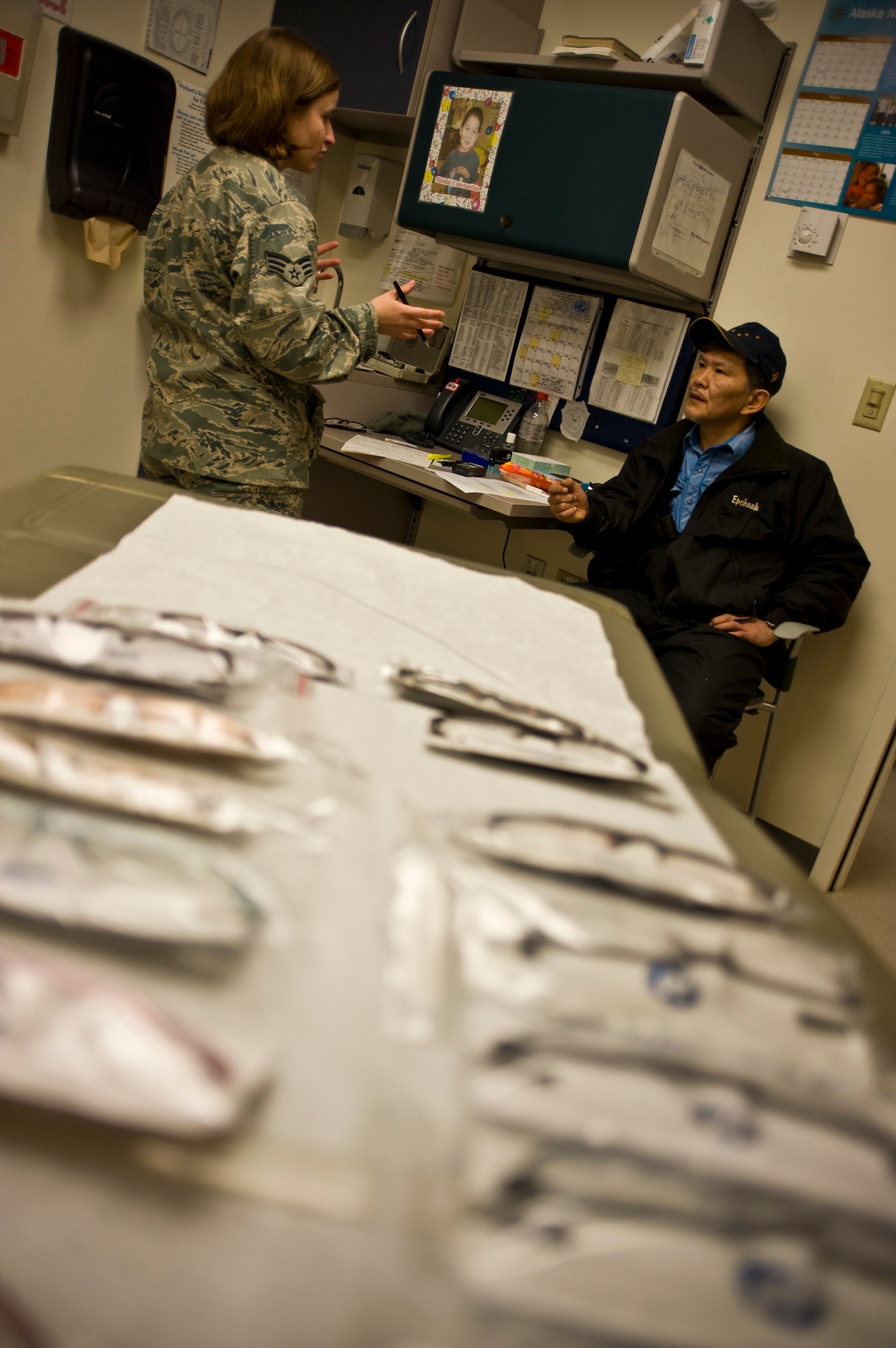 Senior Airman Samantha Reed, an optometry technician at McConnell Air Force Base, talks with a patient before conducting an eye examination at a health clinic in Kwethluk, Alaska, on March 10, 2009. A joint military medical team is deployed to Kwethluk, a small village in Western Alaska, in support of Operation Arctic Care. This year's Navy-led mission has teams in 11 villages in Alaska's Yukon-Kuskokwim Delta region providing medical, dental and veterinary support at no-cost to Alaskan natives. (U.S. Air Force photo by Senior Airman Christopher Griffin)