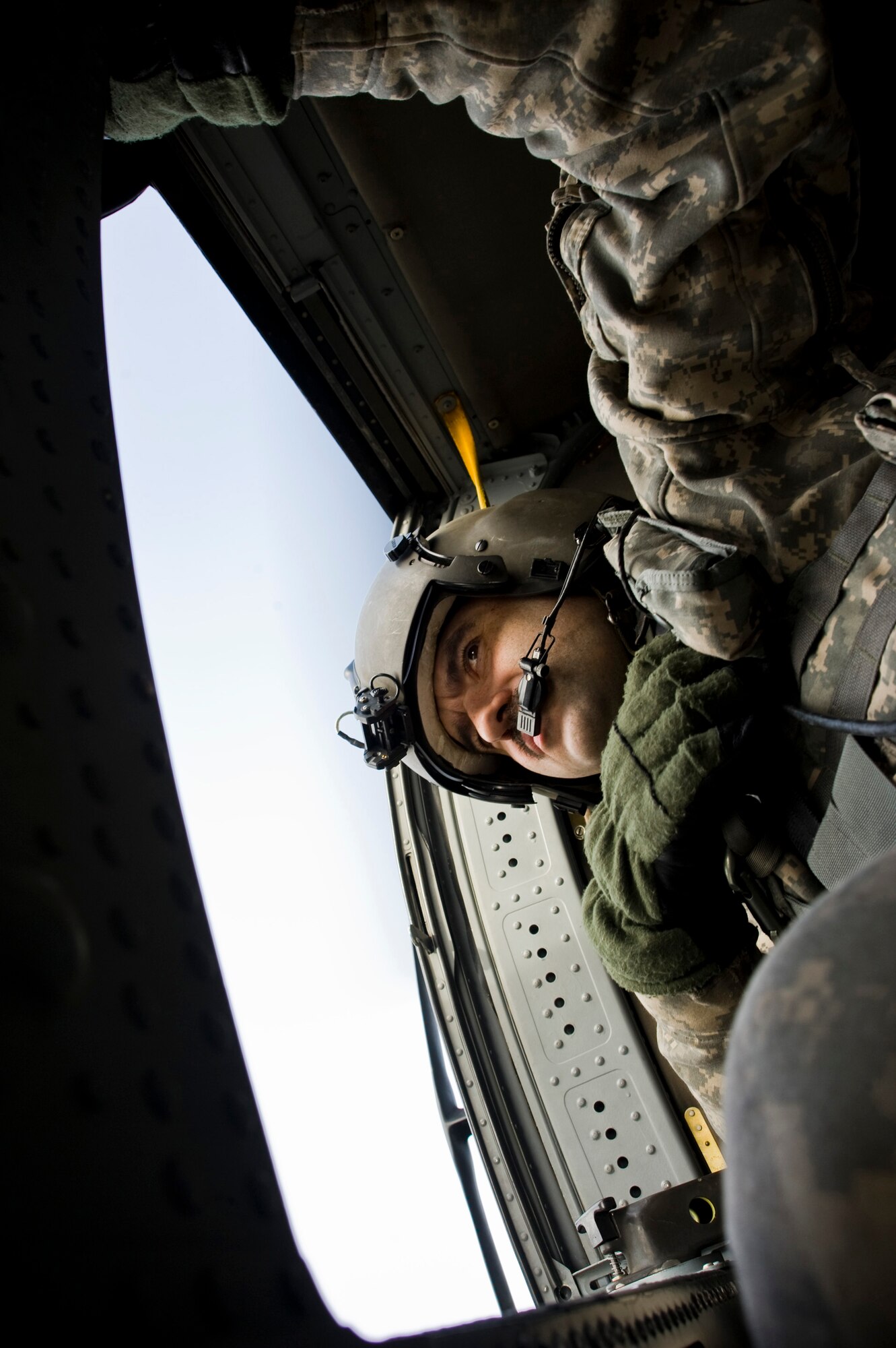 Sgt. Donald Chapman of the Alaska Army National Guard's 1st 207 Aviation Regiment scans a village for a safe landing area March 12, 2009. The 1st 207 Aviation Regiment is responsible for transporting all medical teams and supplies during Operation Arctic Care, a Navy-led readiness exercise providing no-cost health care to 14 villages in Western Alaska's Yukon-Kuskokwim region. (U.S. Air Force photo by Senior Airman Christopher Griffin)