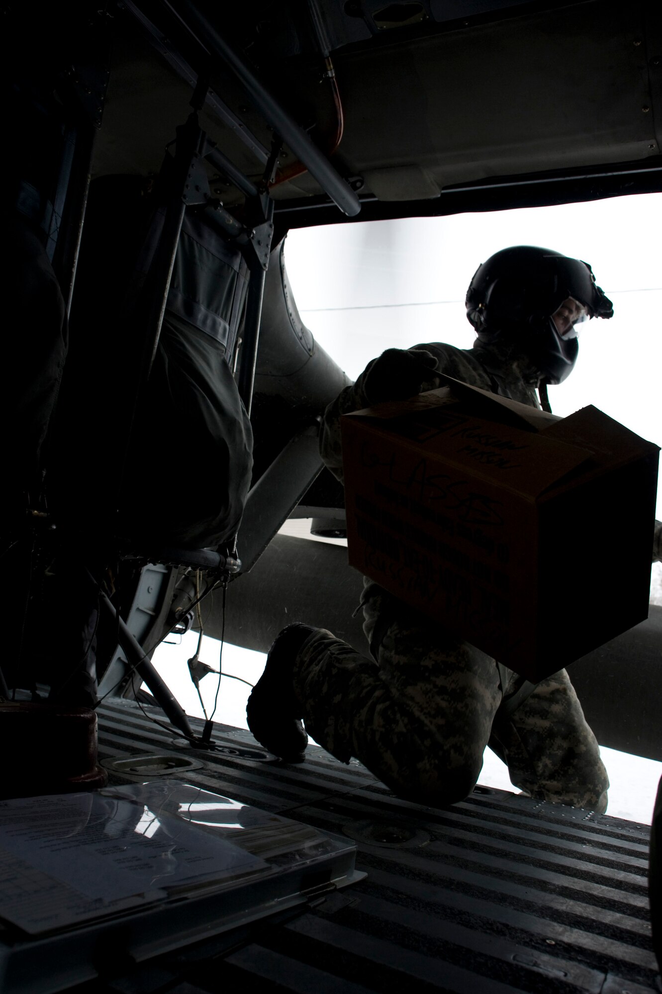 Sgt. Robert Pike of the Alaska Army National Guard's 1st 207 Aviation Regiment unloads medical supplies from a Black Hawk in a Western Alaska village March 12, 2009. The 1st 207 Aviation Regiment is responsible for transporting all medical teams and supplies during Operation Arctic Care, a Navy-led readiness exercise providing no-cost health care to 14 villages in Western Alaska's Yukon-Kuskokwim region. (U.S. Air Force photo by Senior Airman Christopher Griffin)