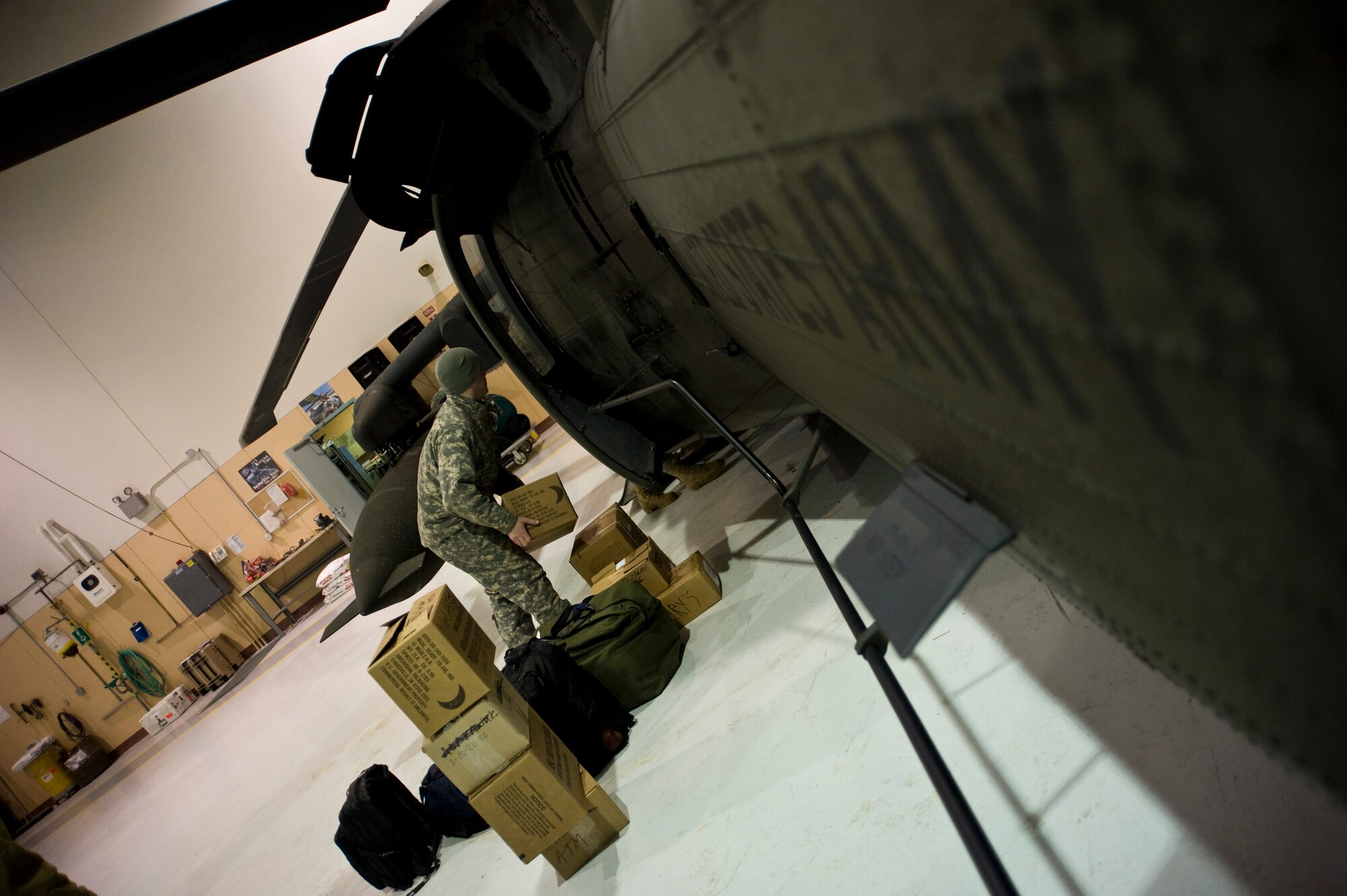 Sgt. Robert Pike of the Alaska Army National Guard's 1st 207 Aviation Regiment loads a Black Hawk with medical supplies in Bethel, Alaska, March 12, 2009. The 1st 207 Aviation Regiment is responsible for transporting all medical teams and supplies during Operation Arctic Care, a Navy-led readiness exercise providing no-cost health care to 14 villages in Western Alaska's Yukon-Kuskokwim region. (U.S. Air Force photo by Senior Airman Christopher Griffin)
