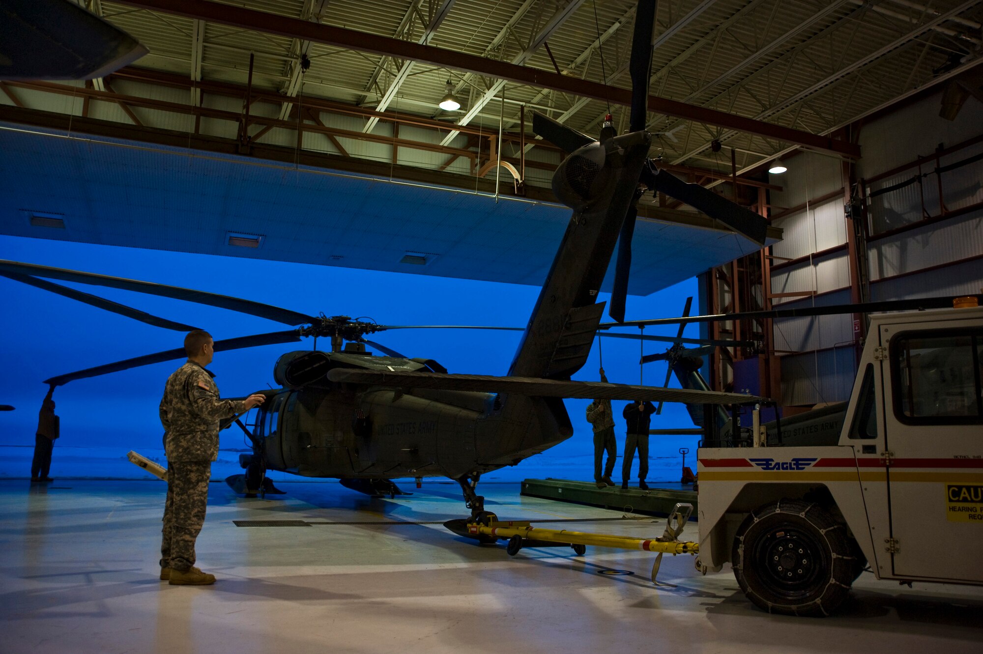 Soldiers from the Alaska Army National Guard's 1st 207 Aviation Regiment guide a Black Hawk onto the flight line in Bethel, Alaska, March 12, 2009. The 1st 207 Aviation Regiment is responsible for transporting all medical teams and supplies during Operation Arctic Care, a Navy-led readiness exercise providing no-cost health care to 14 villages in Western Alaska's Yukon-Kuskokwim region. (U.S. Air Force photo by Senior Airman Christopher Griffin)