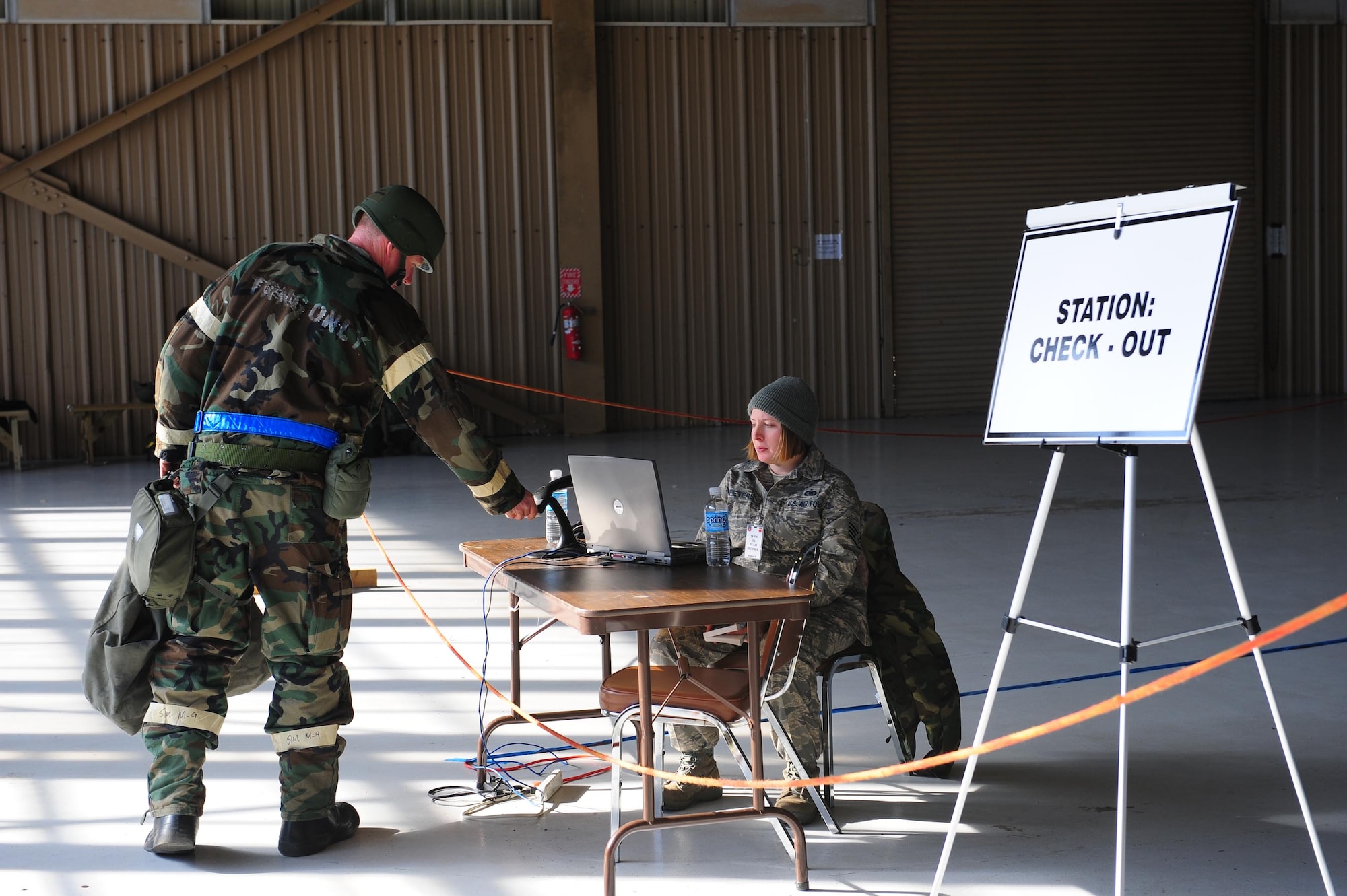 SHAW AIR FORCE BASE, S.C. -- An exercise player performs his final official duty before going home. The transition area provides a safe place for Airmen to pack away their MOPP gear and call it a night. (U.S. Air Force photo/Staff Sgt. Henry Hoegen)