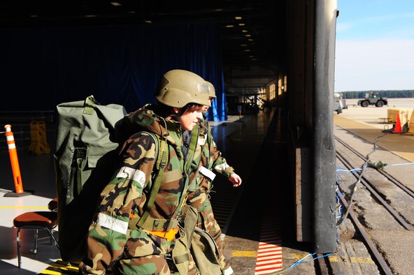 SHAW AIR FORCE BASE, S.C. -- Two exercise participants leave Hangar 1200 to join the war. Once they leave the transition area, they are subject to all scenarios and must perform accordingly. (U.S. Air Force photo/Staff Sgt. Henry Hoegen)