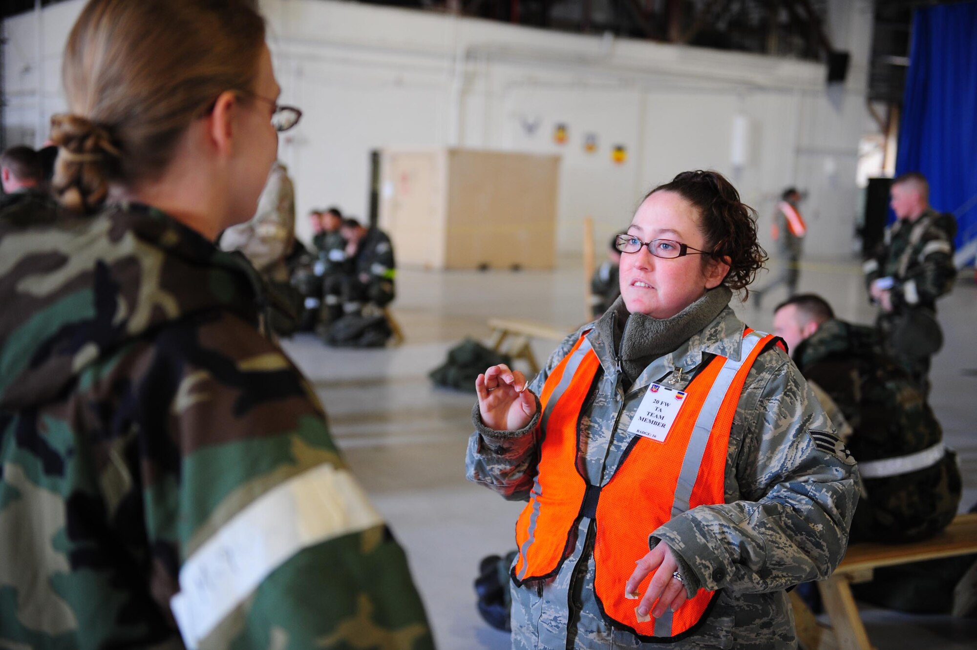 SHAW AIR FORCE BASE, S.C. -- A transition area attendant inspects an Airman's MOPP gear before allowing her to leave the hangar. Checking gear and quizzing participants on exercise knowledge helps ensure people are ready for evaluations. (U.S. Air Force photo/Staff Sergeant Henry Hoegen)