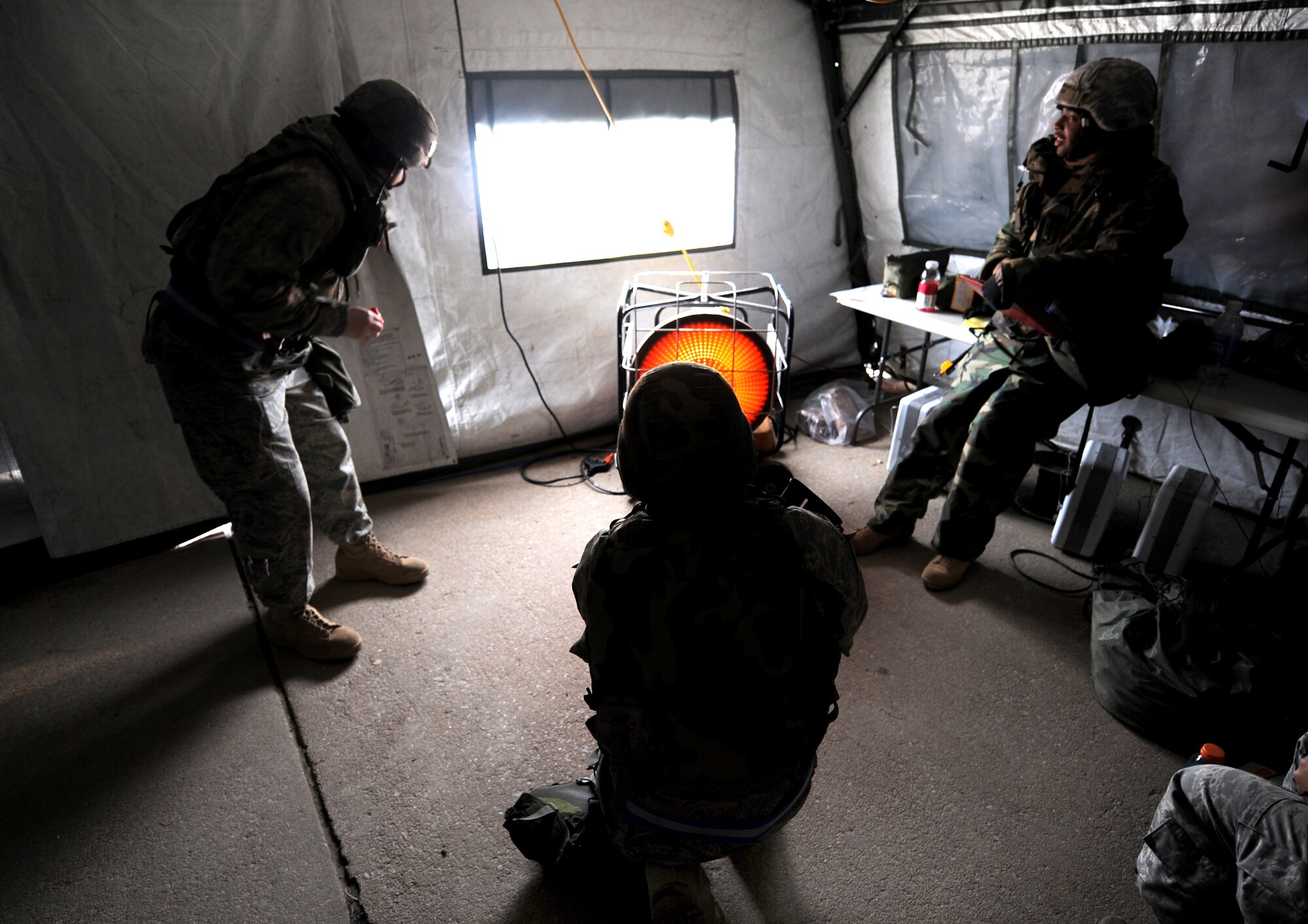 OFFUTT AIR FORCE BASE, Neb. -- Airmen assigned to the 55th Security Forces Squadron dethaw inside the Echo 1 entry control point tent while participating in an Operational Readiness Exercise March 10. 55th Wing Airmen went through a thorough three day exercise to test their mission skills prior to deploying. The wing will be conducting exercises in preparation for an Operational Readiness Inspection Sept. 10-16. 
 U.S. Air Force Photo by Josh Plueger
(CLEARED)
