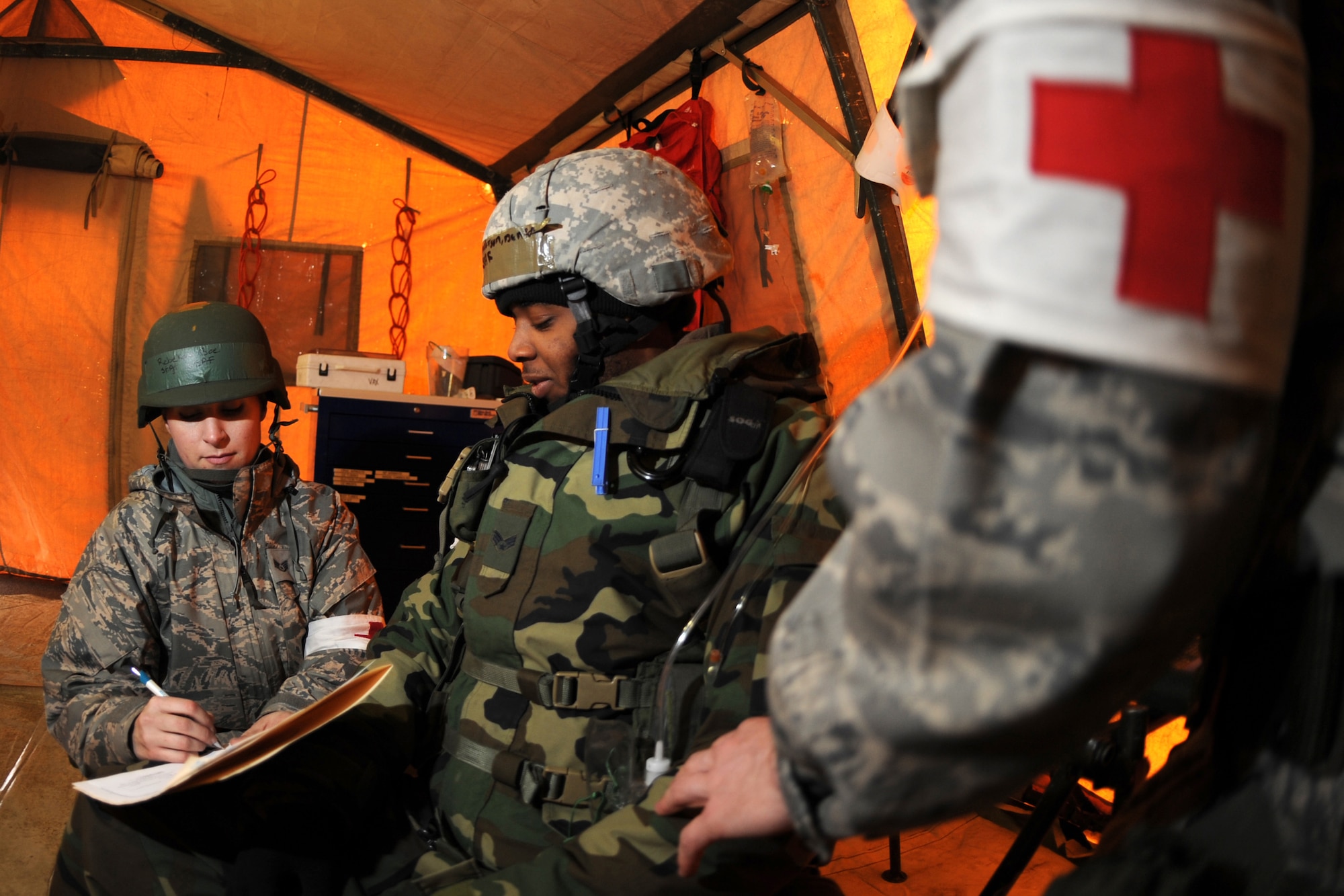 OFFUTT AIR FORCE BASE, Neb. -- Staff Sgt. Rebekah Boe, a medical technician with the Women's Health Clinic, charts information about SrA Denton Anderson, 55th Security Forces Squadron, after a simulated ground attack occurred at base "X."  SrA Anderson was one of four casualties in the ground attack receiving a gunshot wound to the shoulder as part of an Operational Readiness Exercise March 10, 2009. 55th Wing Airmen went through a thorough three day exercise to test their mission skills prior to deploying. The 55th wing is in preparation for an Operational Readiness Inspection Sept. 10-16. U.S. Air Force Photo by Josh Plueger
(CLEARED)
