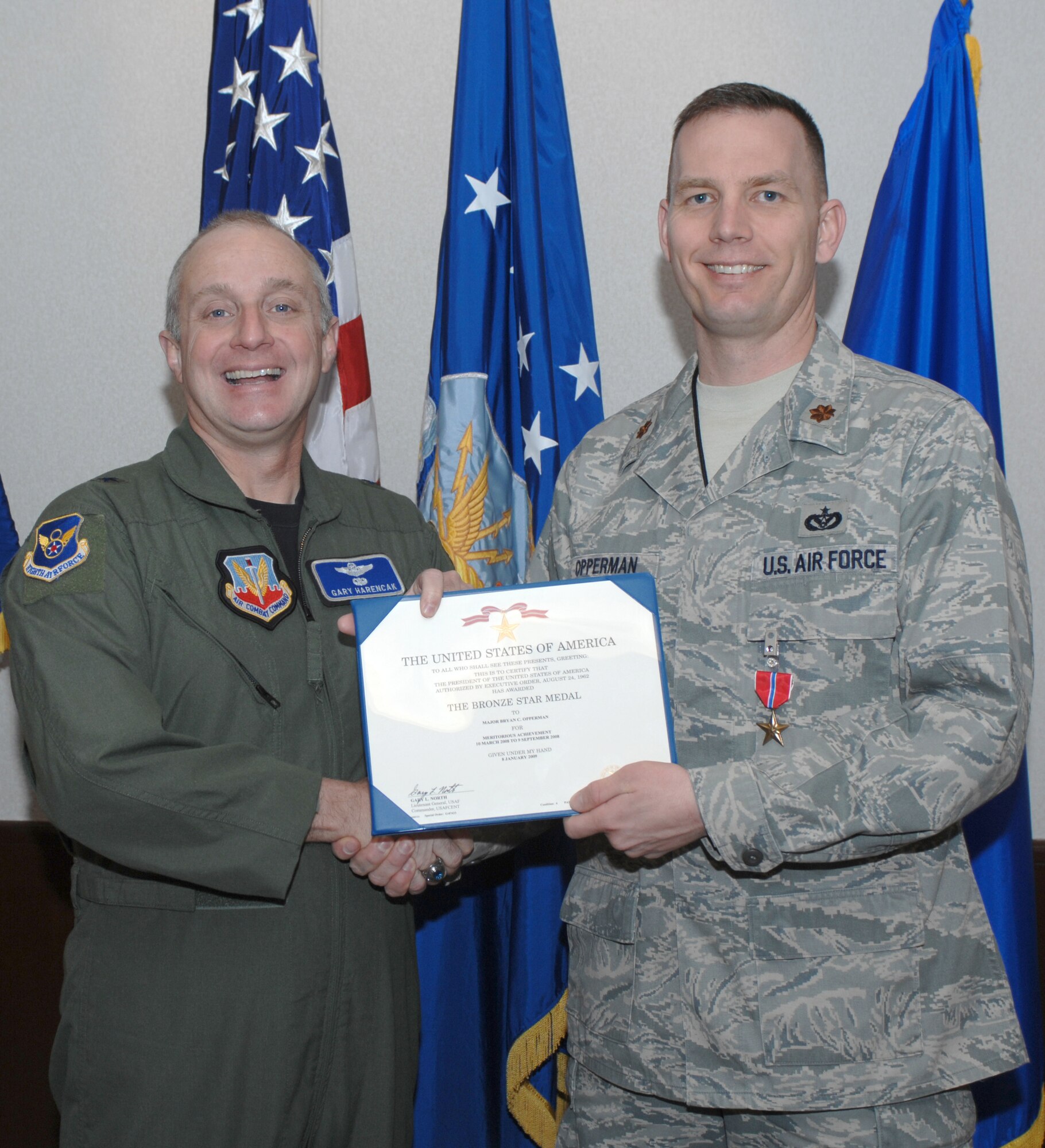 WHITEMAN AIR FORCE BASE, Mo. – Brig. Gen. Garrett Harencak, 509th Bomb Wing commander presents Maj. Bryan Opperman, 509th Civil Engineer Squadron commander, with a Bronze Star here March 12. Major Opperman’s accomplishments include overseeing an Iraqi Army Engineering training program which teamed U.S. craftsmen and Iraqi trainees to teach them plumbing and electrical skills essential for Iraqi base maintenance. (U.S. Air Force photo/Capt. Matthew Miller)
