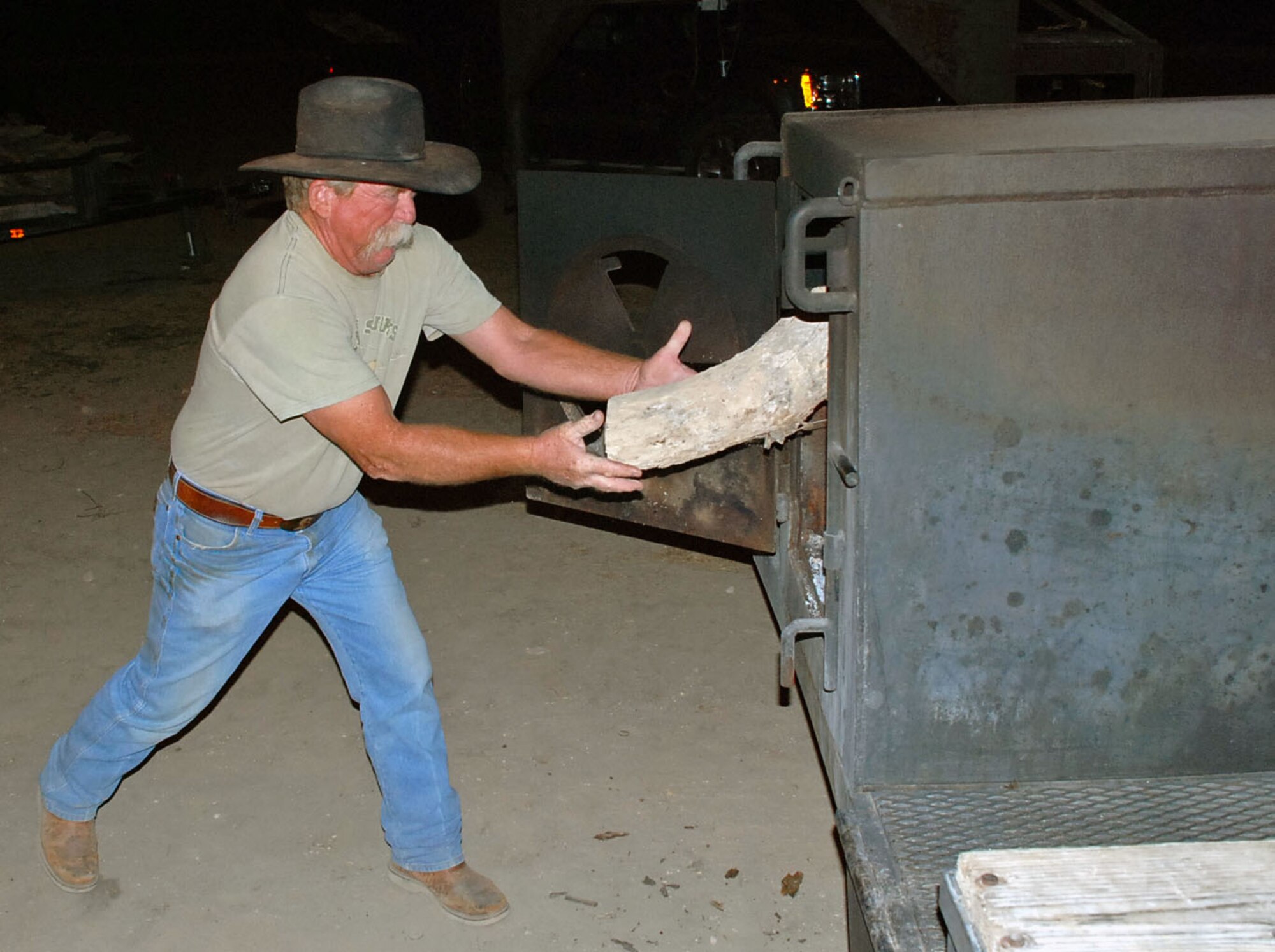 LAUGHLIN AIR FORCE BASE, Texas – A volunteer from Del Rio starts the fire for brisket and beans to pass out to the Del Rio community during a fundraising event in Del Rio March 7. The fundraiser was sponsored by the Del Rio Chamber of Commerce Military Affairs Association to help raise money for Laughlin’s upcoming Dining Out. (U.S. Air Force photo by Tech Sgt. Joel Langton)