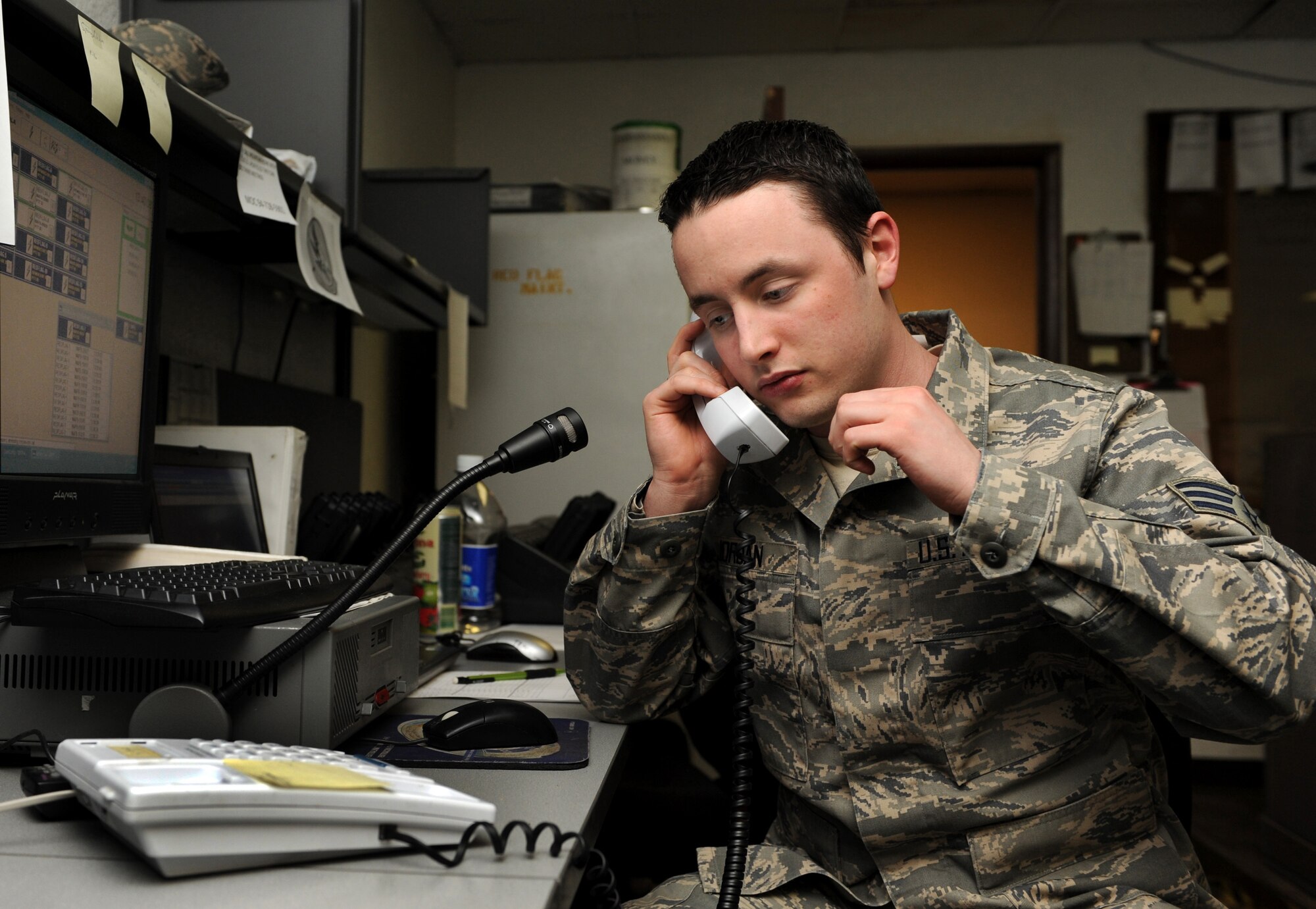 NELLIS AIR FORCE BASE, Nev. -- Senior Airman Collin Jordan, Red Flag Air Expeditionary Wing weapons system controller from Spangdahlem Air Base, Germany, answers questions regarding the runways Nellis while participating in Red Flag 09-3 March 6. The maintenance operations center, or MOC, runs 24 hours a day, seven days a week, to control, track and monitor all maintenance operations on the flightline here. Red Flag is a realistic combat training exercise involving the air forces of the United States and its allies. The exercise is conducted on the 15,000-square-mile Nevada Test and Training Range north of Las Vegas. (U.S. Air Force photo/ Airman 1st Class Debbie Lockhart)