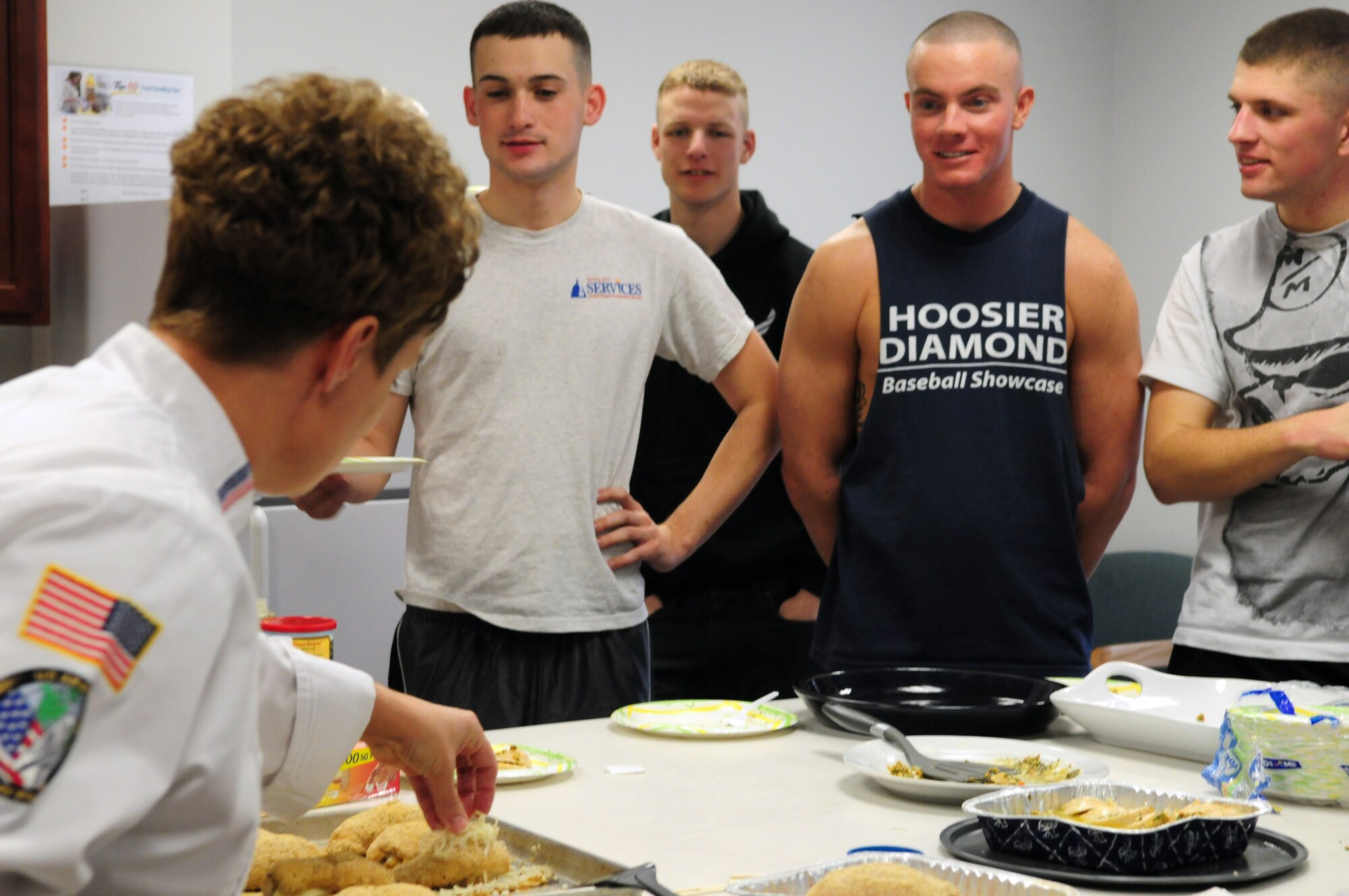 Master Sgt. Jamie Green demonstrates cooking techniques for Airmen at the United States Air Force Honor Guard dormitory March 12. The recipes demonstrated included chicken cordon bleu and poached rolled chicken with parsley and tarragon. These classes are held on a monthly basis and are intended to teach Airmen how to shop, handle and prepare their own meals. (U.S. Air Force photo by Airman 1st Class Susan Moreno)