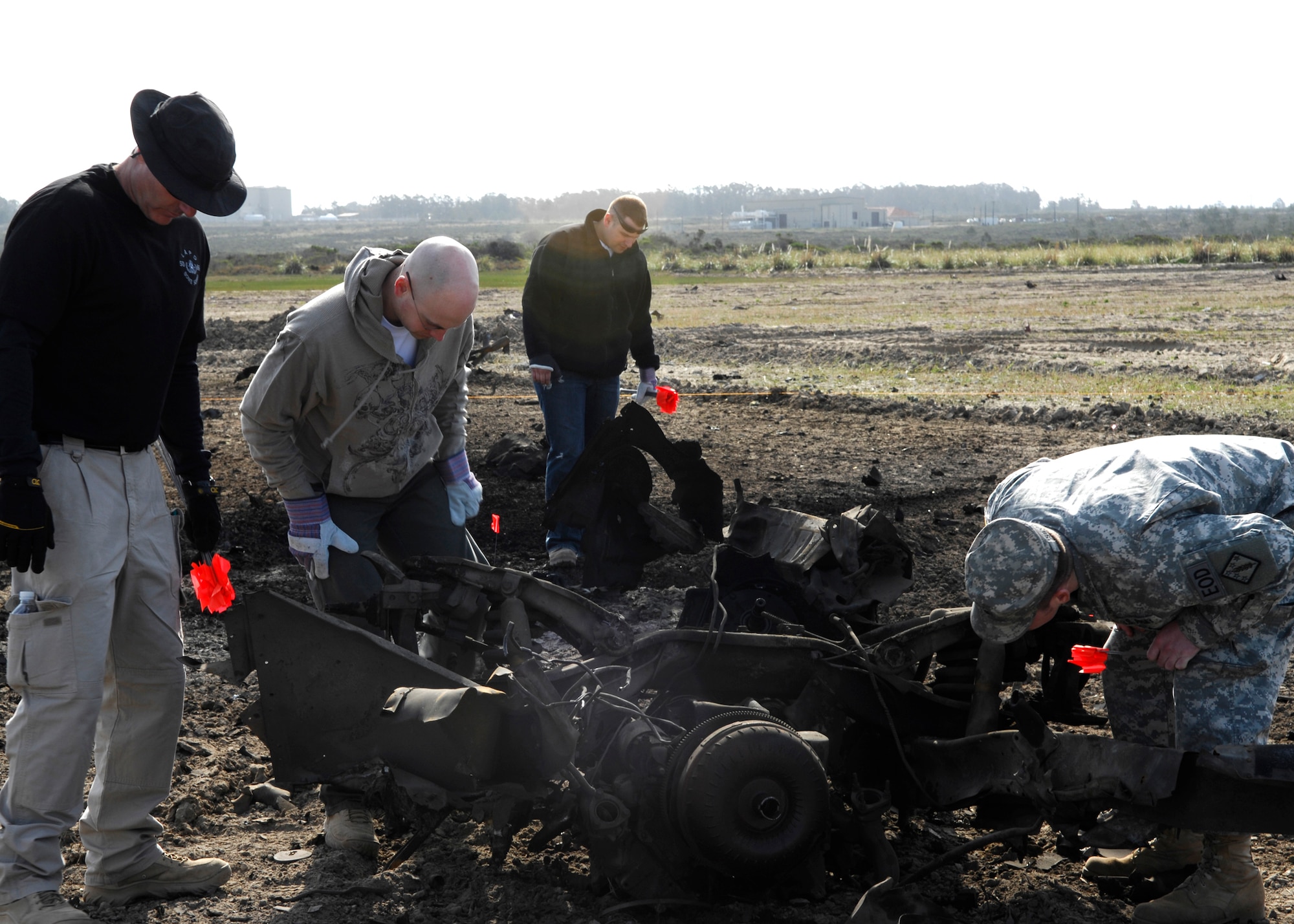 VANDENBERG AIR FORCE BASE, Calif.- Members of the FBI Large Vehicle Bomb Post Blast class investigate the blast site of the vehicle detonated by Vandenberg's Explosive Ordnance Disposal team March 11 here.  The class hosted a number of actors studying techniques used by the FBI and EOD for use in future roles in an upcoming television show.  (U.S. Air Force photo\Airman 1st Class Heather R. Shaw)