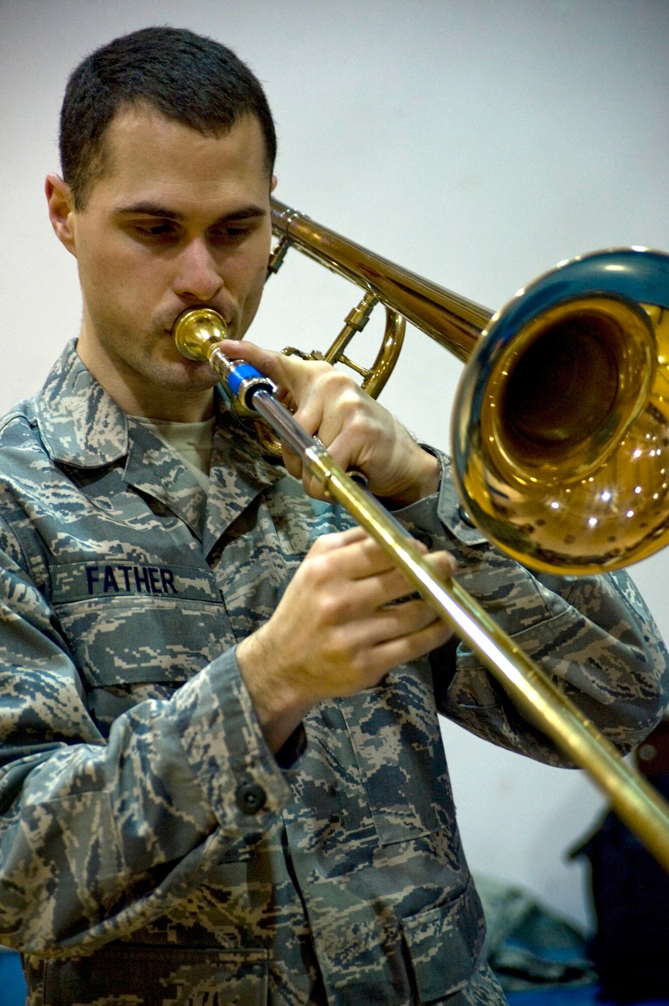 Senior Airman George Father of the U.S. Air Force Band of the Pacific's Alaska Brass prepares his trombone before playing for students at Ignatius Beans Sr. School in Mountain Village, Alaska, on March 11, 2009. The concert of the five-piece brass and percussion ensemble was part of Operation Arctic Care, a Navy-led medical readiness exercise providing no-cost health care and veterinary support to 12 villages in Western Alaska. (U.S. Air Force photo by Senior Airman Christopher Griffin)