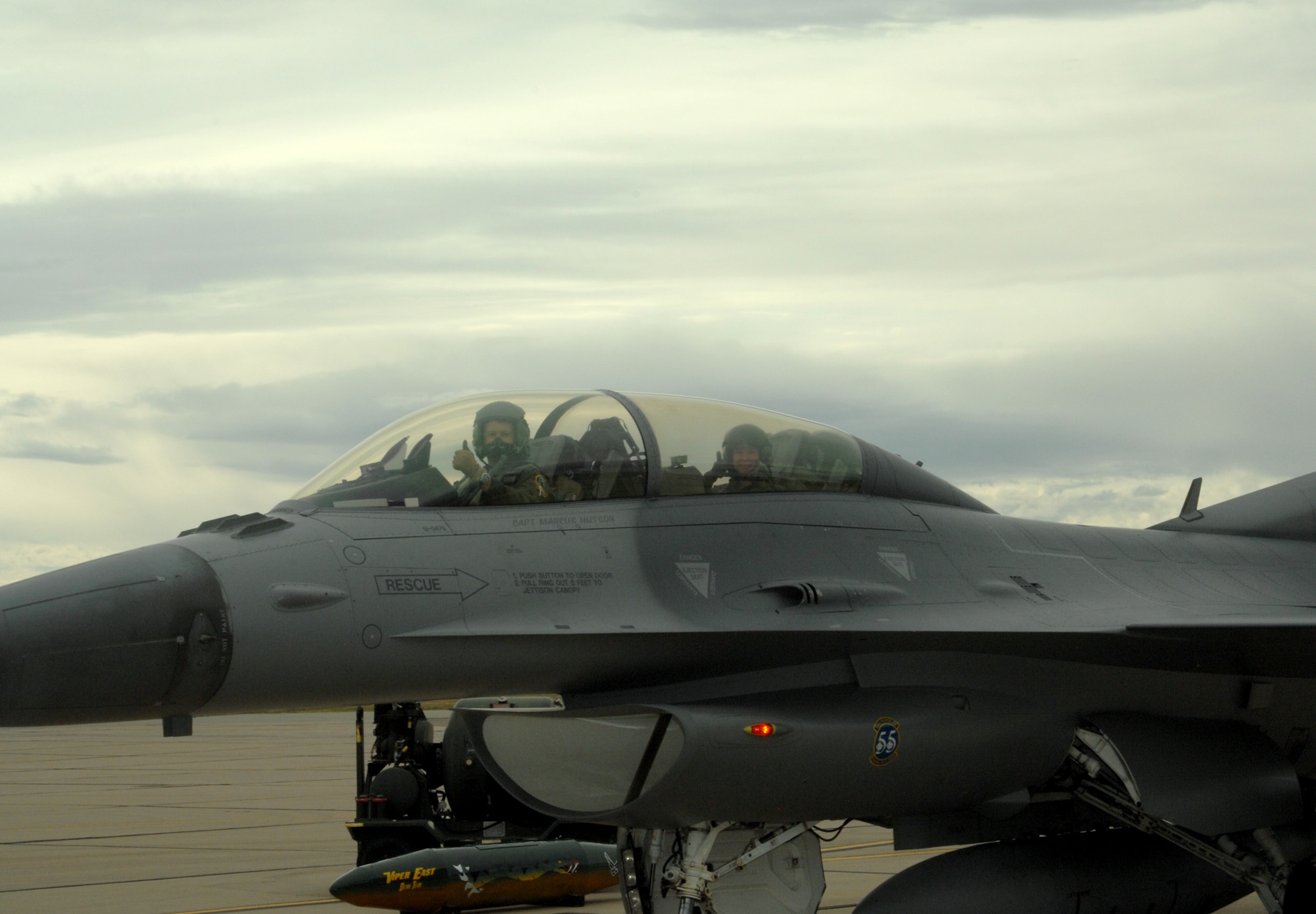 Lt. Col. Todd Hamilton, an F-16 pilot from Shaw Air Force Base, S.C., and Senior Airman Heather Maldonado of the 355th Equipment Maintenance Squadron here give the universal "thumbs-up" signal as they taxi down the runway before an incentive flight March 6. (U.S. Air Force photo/Staff Sgt. Jake Richmond)