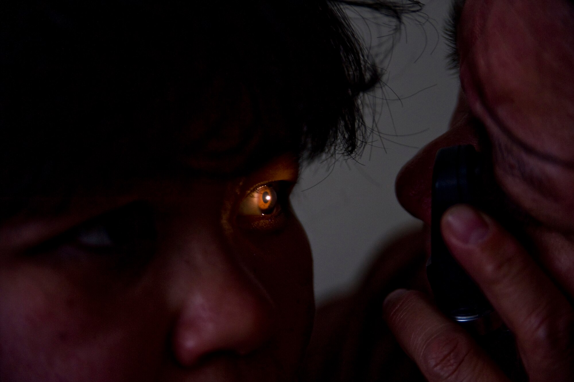 Navy Cmdr. Nancy Moya of Pueblo, Colo., attached to Operational Health Support Unit Bremerton Detachment P, examines Carole Alexie's retinas during a health physical in Mountain Village, Alaska, on March 11, 2009. A joint military medical team is deployed to Mountain Village in support of Operation Arctic Care. This year's Navy-led mission has teams in 14 villages in Alaska's Yukon-Kuskokwim Delta region providing medical, dental and veterinary support at no cost to Alaskan natives. (U.S. Air Force photo by Senior Airman Christopher Griffin)

