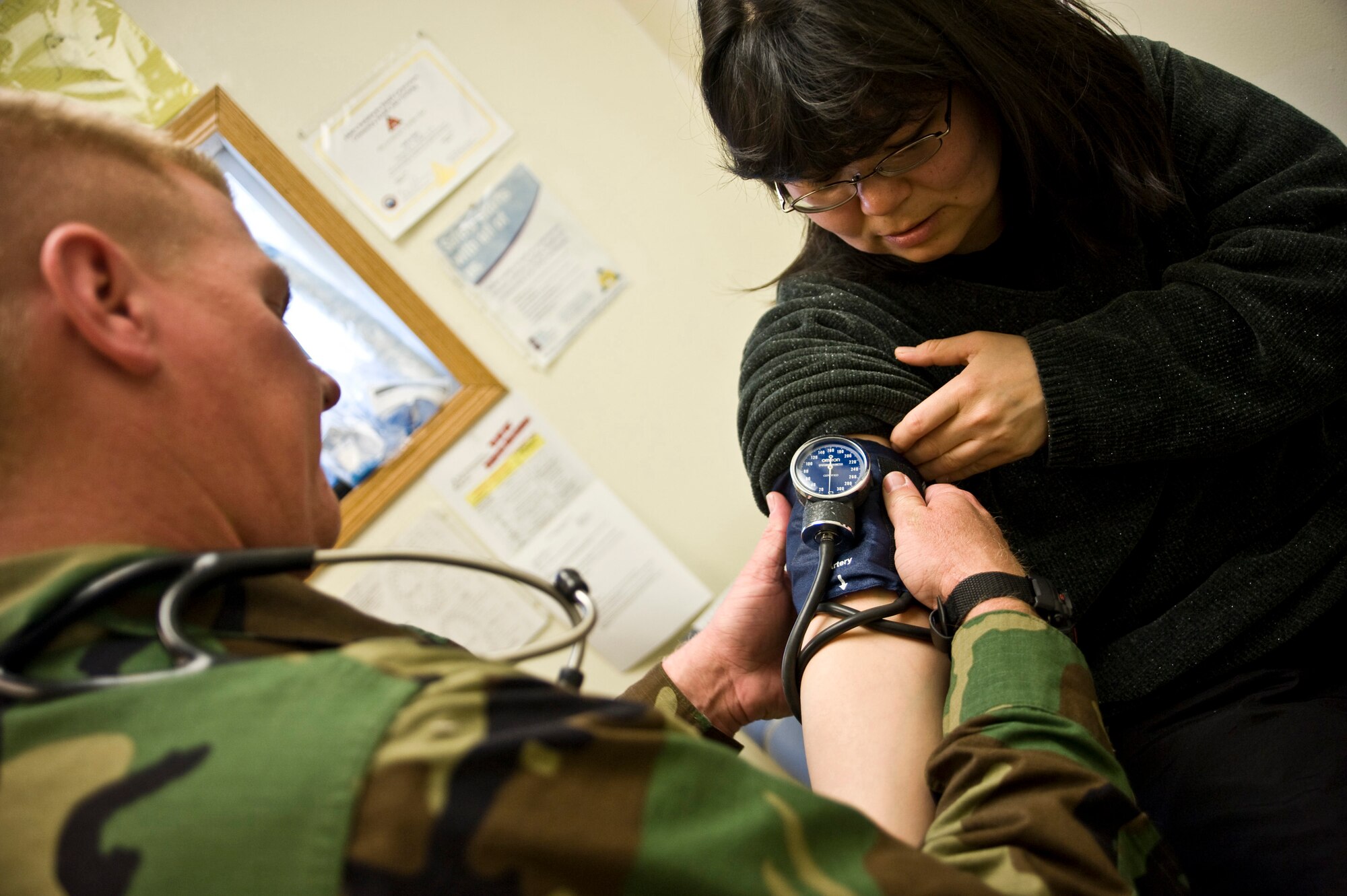 Navy Hospital Corpsman 2nd Class Chris Lutton of Simi Valley, Calif., attached to the 4th Marine Division, Weapons Company 223, checks Martha Wasky's blood pressure during her health physical in Mountain Village, Alaska, on March 11, 2009. A joint military medical team is deployed to Mountain Village in Western Alaska, in support of Operation Arctic Care. This year's Navy-led mission has teams in 14 villages in Alaska's Yukon-Kuskokwim Delta region providing medical, dental and veterinary support at no cost to Alaskan natives. (U.S. Air Force photo by Senior Airman Christopher Griffin)