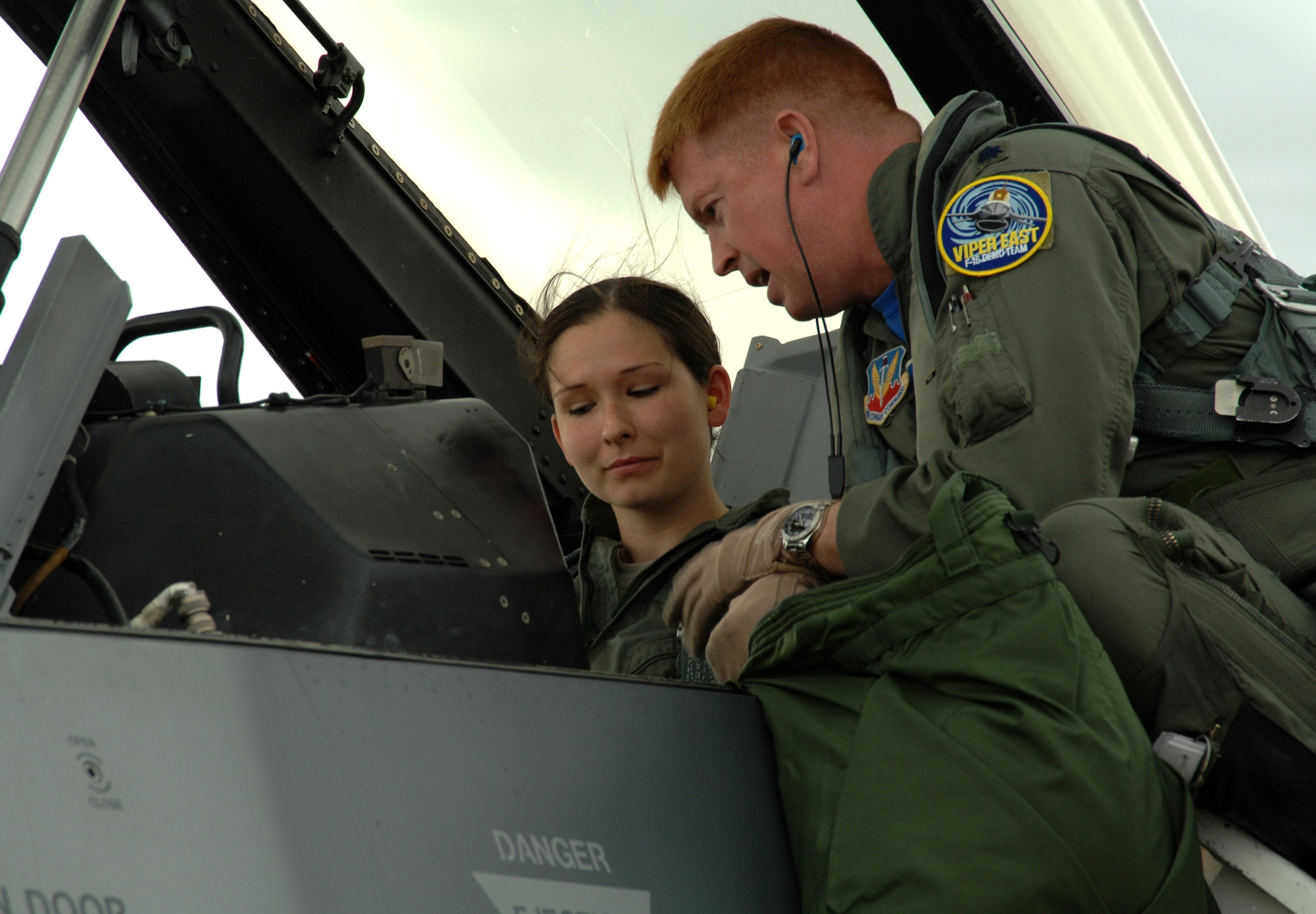 Lt. Col. Todd Hamilton, an F-16 pilot from Shaw Air Force Base, S.C., familiarizes Senior Airman Heather Maldonado with the cockpit of an F-16 Fighting Falcon before taking her on an incentive flight here March 6. Airman Maldonado, a member of the 355th Equipment Maintenance Squadron here, was one of several D-M award selectees who got the opportunity to ride in one of the demonstration jets visiting the base for the Heritage Flight Conference. (U.S. Air Force photo/Staff Sgt. Jake Richmond)