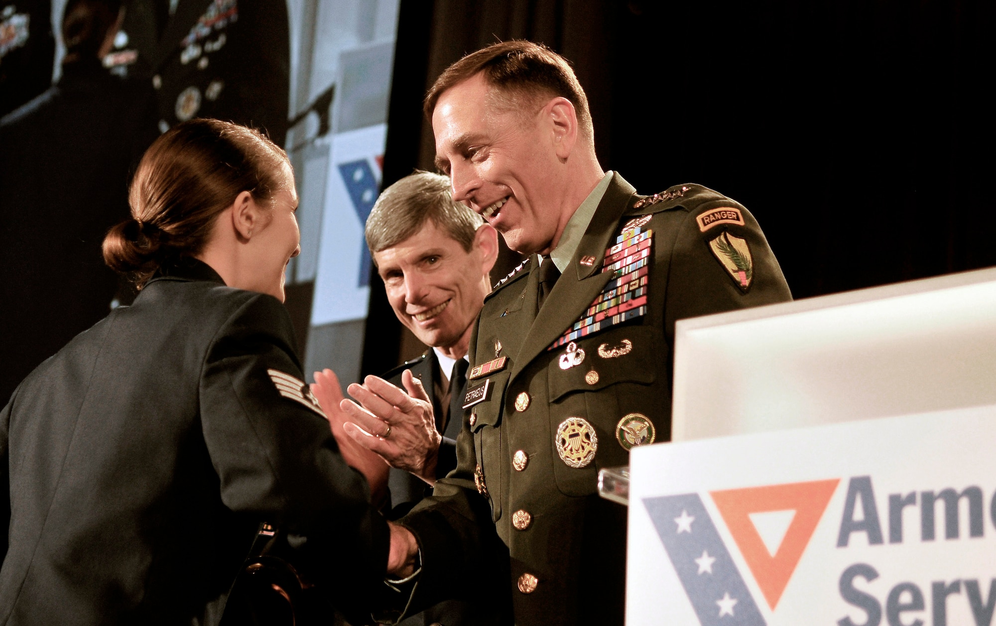 Staff Sgt. Stephanie Cates receives the Angels of the Battlefield Award from Army Gen. David Petraeus and Gen. Norton Schwartz during a dinner in honor of military medics and corpsman March 11 at the Ronald Reagan Building in Washington, D.C. General Patraeus is the commander of U.S. Central Command. General Schwartz is the Air Force chief of staff. (U.S. Air Force photo/Tech. Sgt. Suzanne M. Day) 
