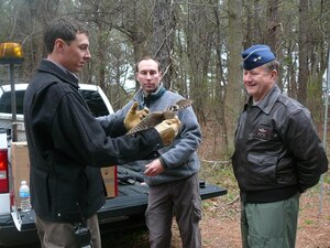 LANGLEY AIR FORCE BASE, Va. -- Maj. Gen Fredrick F. Roggero, Air Force Chief of Safety (right), listens as Tom Olexa (left) and Jared Kwitowski (center), USDA wildlife biologists, explain the different species of birds that inhabit the airfield environment around Langley March 12.  Mr. Olexa and Mr. Kwitowski showed General Roggero a red-tailed hawk and an American kestrel that had been caught and removed from the airfield.  They discussed the types of live traps used to catch the birds as part of the Bird Aircraft Strike Hazard program.  The USDA has 25 full-time biologists stationed at Air Force installations around the country as part of their wildlife services programs.  (U.S. Air Force photo)