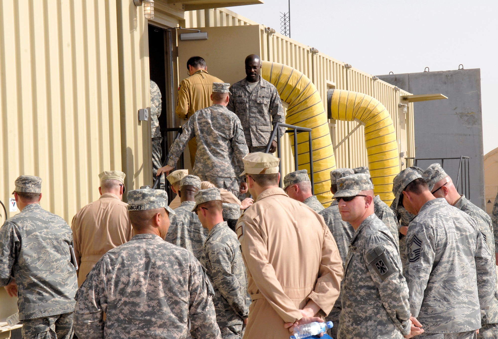 U.S. and coalition forces enter the new Battlespace Command and Control Center during its opening Feb. 26 at an air base in Southwest Asia. The $30 million facility allows the squadron's operators and technicians to pull real-time information from Air Force, Navy and Army sensor systems in the region. (U.S. Air Force photo/Airman 1st Class Andrew Satran) 
