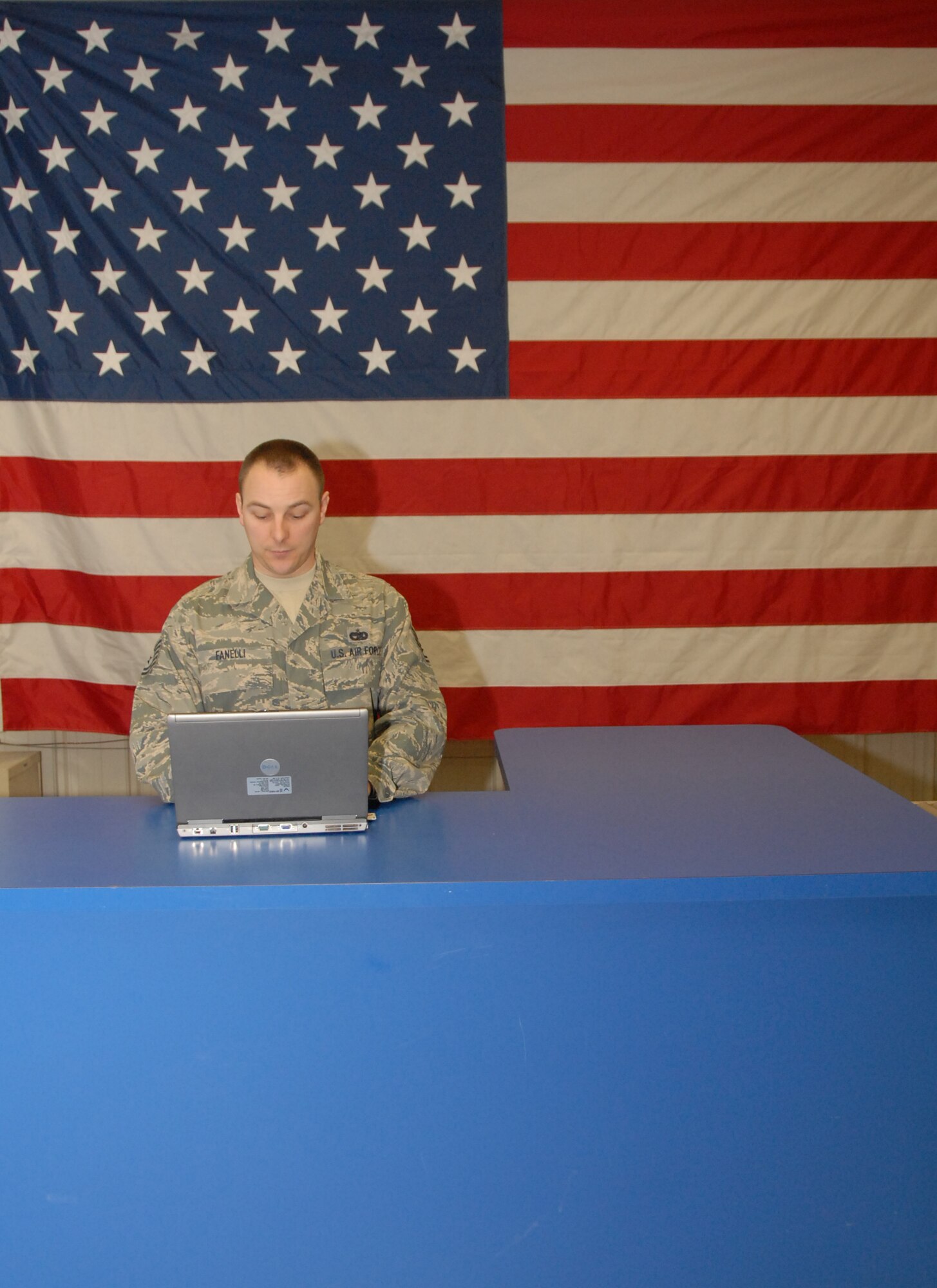 Tech Sgt. Christopher D. Fanelli, air transportation craftsman, 103rd Logistics Readiness Squadron, stands ready at the customer service counter at the Bradley Air National Guard Base, East Granby, Conn. Feb. 25, 2009.   (U.S. Air Force Photo by Capt. Bryon M. Turner)
