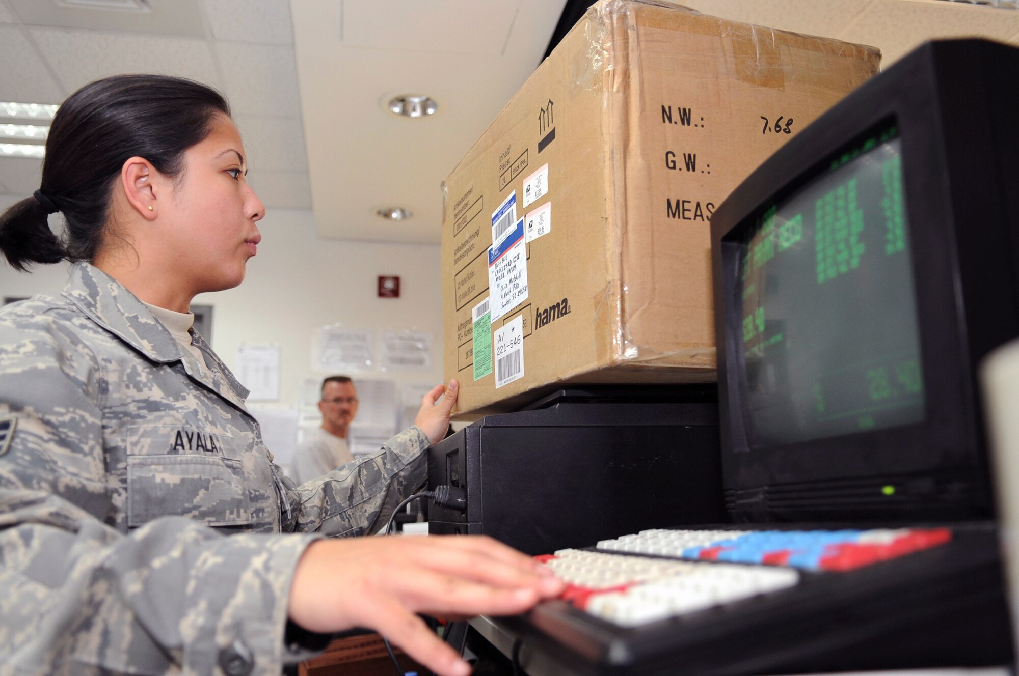 Senior Airman Mereille Ayala, a postal clerk with the 379th Expeditionary Communication Squadron, processes a package at the base post office, March 13, 2009, in an undisclosed location in Southwest Asia.  The postage amount to mail packages is determined by the weight and final destination of the parcel.  Airman Ayala is native to Fairbanks, Alaska and is deployed from Spangdahlem Air Base, Germany, in support of Operations Iraqi and Enduring Freedom and Combined Joint Task Force - Horn of Africa.(U.S. Air Force Photo by Staff Sgt. Joshua Garcia/released)