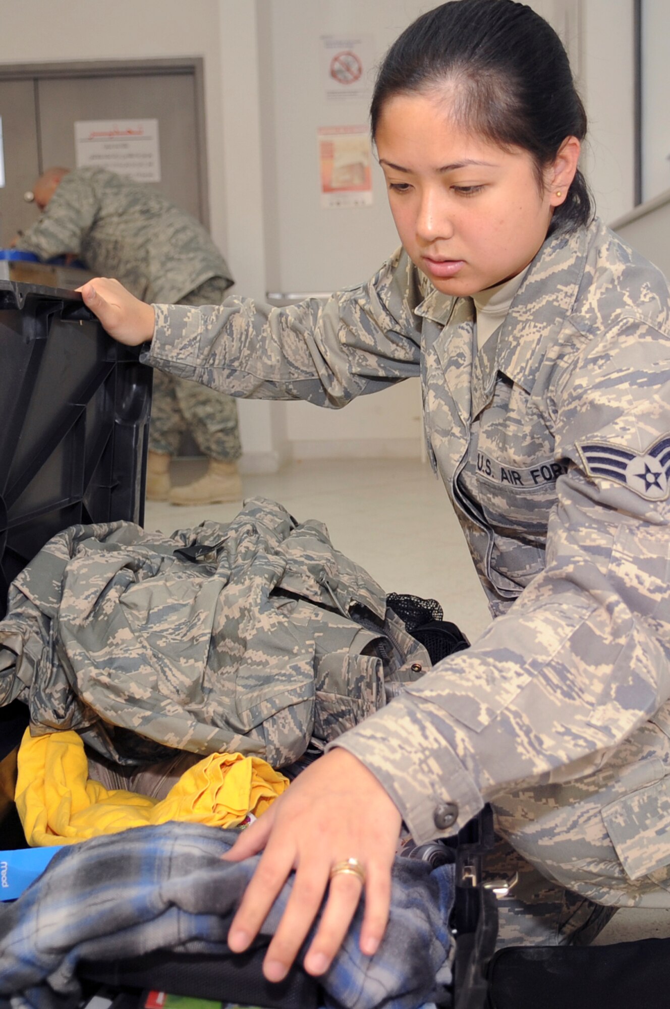 Senior Airman Mereille Ayala, a postal clerk with the 379th Expeditionary Communication Squadron, inspects a package prior to receiving it for shipment, March 13, 2009, in an undisclosed location in Southwest Asia.  All outgoing mail is inspected to ensure there is no contraband leaving the area.  Airman Ayala is native to Fairbanks, Alaska and is deployed from Spangdahlem Air Base, Germany in support of Operations Iraqi and Enduring Freedom and Combined Joint Task Force - Horn of Africa.  (U.S. Air Force Photo by Staff Sgt. Joshua Garcia/released)