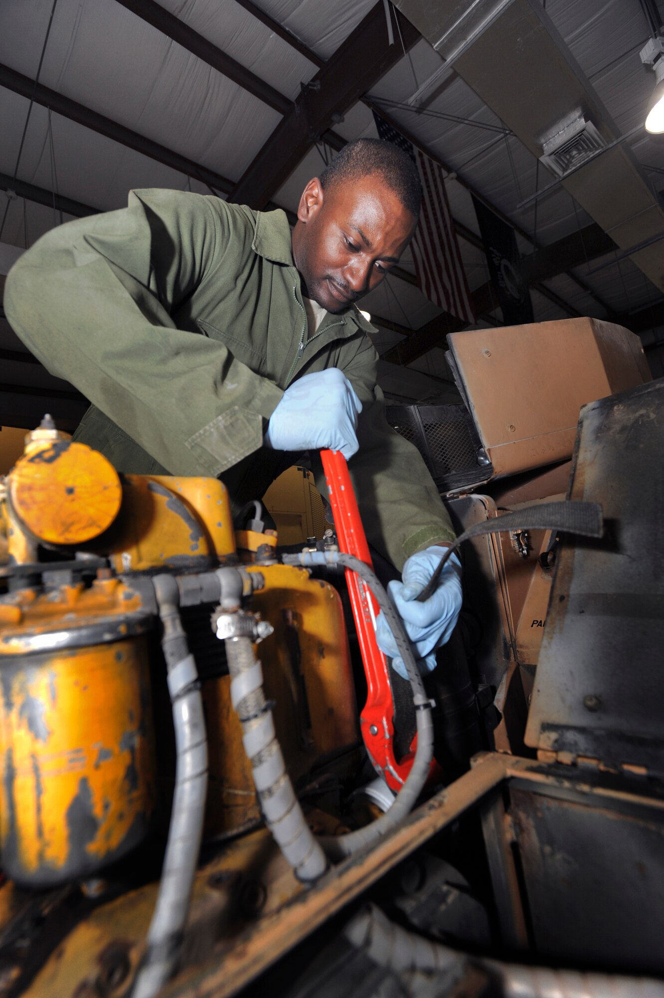 Senior Airman Mario Fortenberry, an Aircraft Ground Equipment mechanic with the 379th Expeditionary Maintenance Squadron, removes an oil filter on a B-1B Lancer bomb lift during its annual inspection, March 10, 2009, in an undisclosed location in Southwest Asia.  Airman Fortenberry and fellow AGE mechanics handle an inventory of over 550 pieces of equipment used to help service every aircraft on the base.  Airman Fortenberry is native to Baton Rouge La. and is deployed from Elmendorf Air Force Base, Alaska in support of Operations Iraqi and Enduring Freedom and Combined Joint Task Force - Horn of Africa.  (U.S. Air Force Photo by Staff Sgt. Joshua Garcia/released)