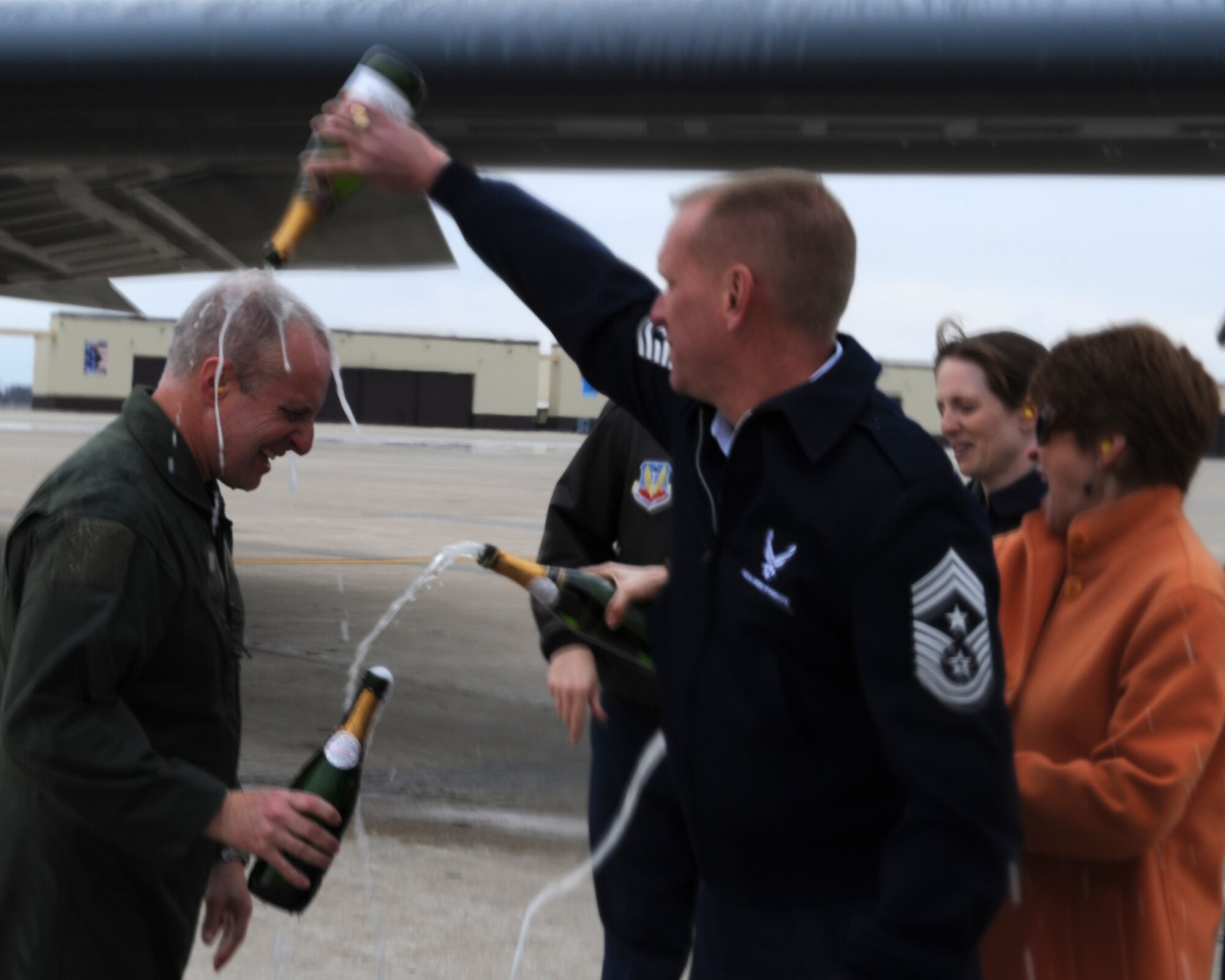 WHITEMAN AIR FORCE BASE, Mo. - Chief Master Sgt. Brian Hornback, 509th Bomb Wing command chief, pours champagne over Brig. Gen. Garrett Harencak, 509th Bomb Wing commander, following his end-of-tour B-2 flight March 9. General Harencak will pass command of the 509th BW to Col. Robert Wheeler, 2d Bomb Wing commander, Barksdale AFB, La., during a change-of-command ceremony March 26. (U.S. Air Force photo/Senior Airman Cory Todd)