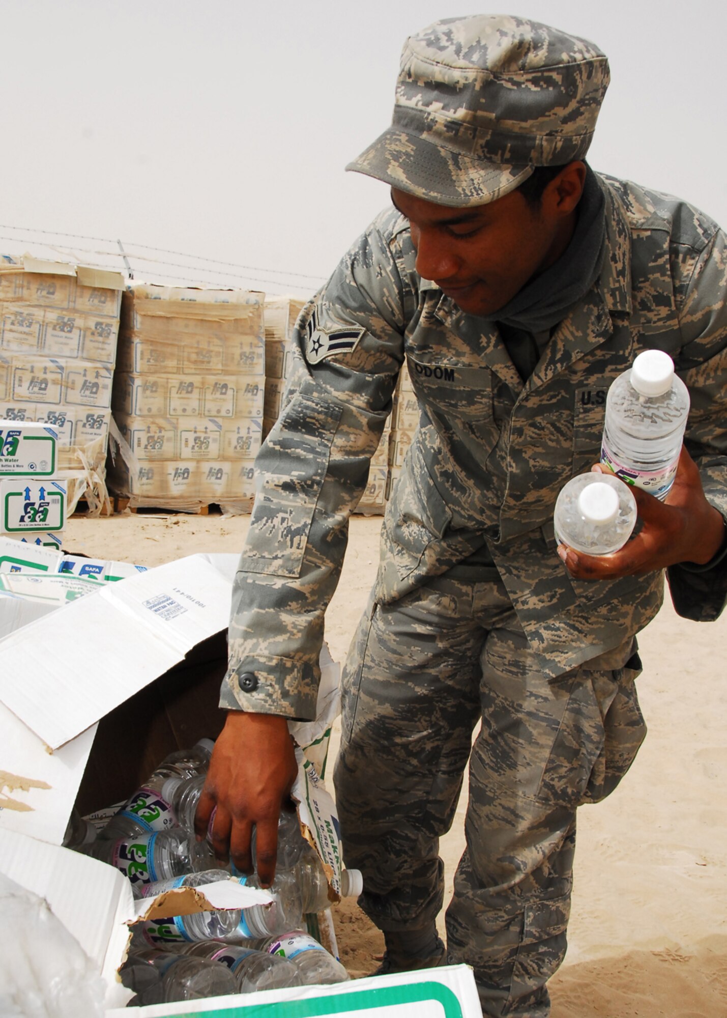 SOUTHWEST ASIA -- Airman 1st Class Adrius Odom, 386th Expeditionary Force Support Squadron, collects water samples for bio-environmental product testing at an air base in Southwest Asia, March 13. The annual distribution to the troops at this base tops out around 2.1 million liters annually. Airman Odom is currently deployed from Dobbins Air Reserve Base, Ga., and is originally from Smryna, Ga. (U.S. Air Force photo/Senior Airman Courtney Richardson)