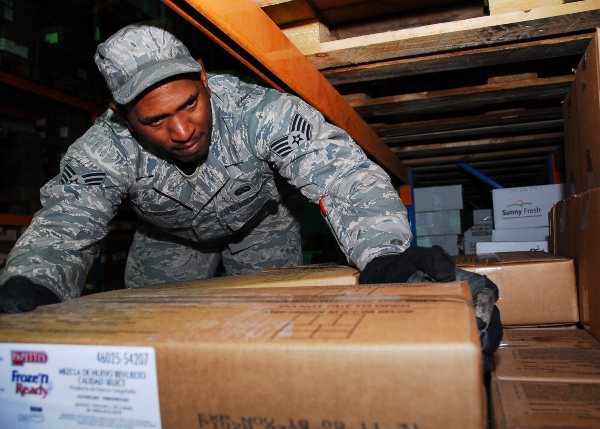 SOUTHWEST ASIA -- Staff Sgt. Lonnie Thomas, 386th Expeditionary Force Support Squadron, restocks the shelves according to the expiration date on the products at an air base in Southwest Asia, March 13. The Ration's staff, consisting of 10 military and civilian personnel, order, receive and maintain the base's food and beverage inventory valued around $2.4 million annually. Sergeant Thomas is currently deployed from the 187th Fighter Wing at  Dannelly Field, Ala. and originally from Montgomery, Ala. (U.S. Air Force photo/Senior Airman Courtney Richardson)