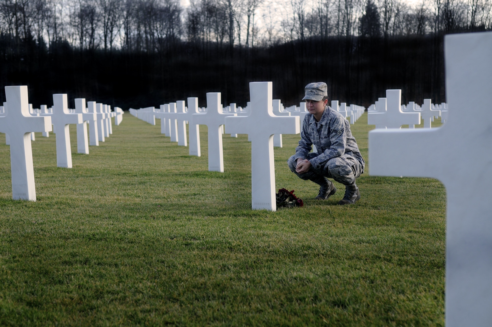 LUXEMBOURG CITY, Luxembourg – Airman 1st Class Jillian Trujillo, 726th Air Mobility Squadron, reads a headstone in the Luxembourg American Cemetery and Memorial March 9, 2009. The cemetery contains the remains of 5,076 American servicemembers from all 50 states and the District of Columbia. (U.S. Air Force photo by Airman 1st Class Staci Miller)