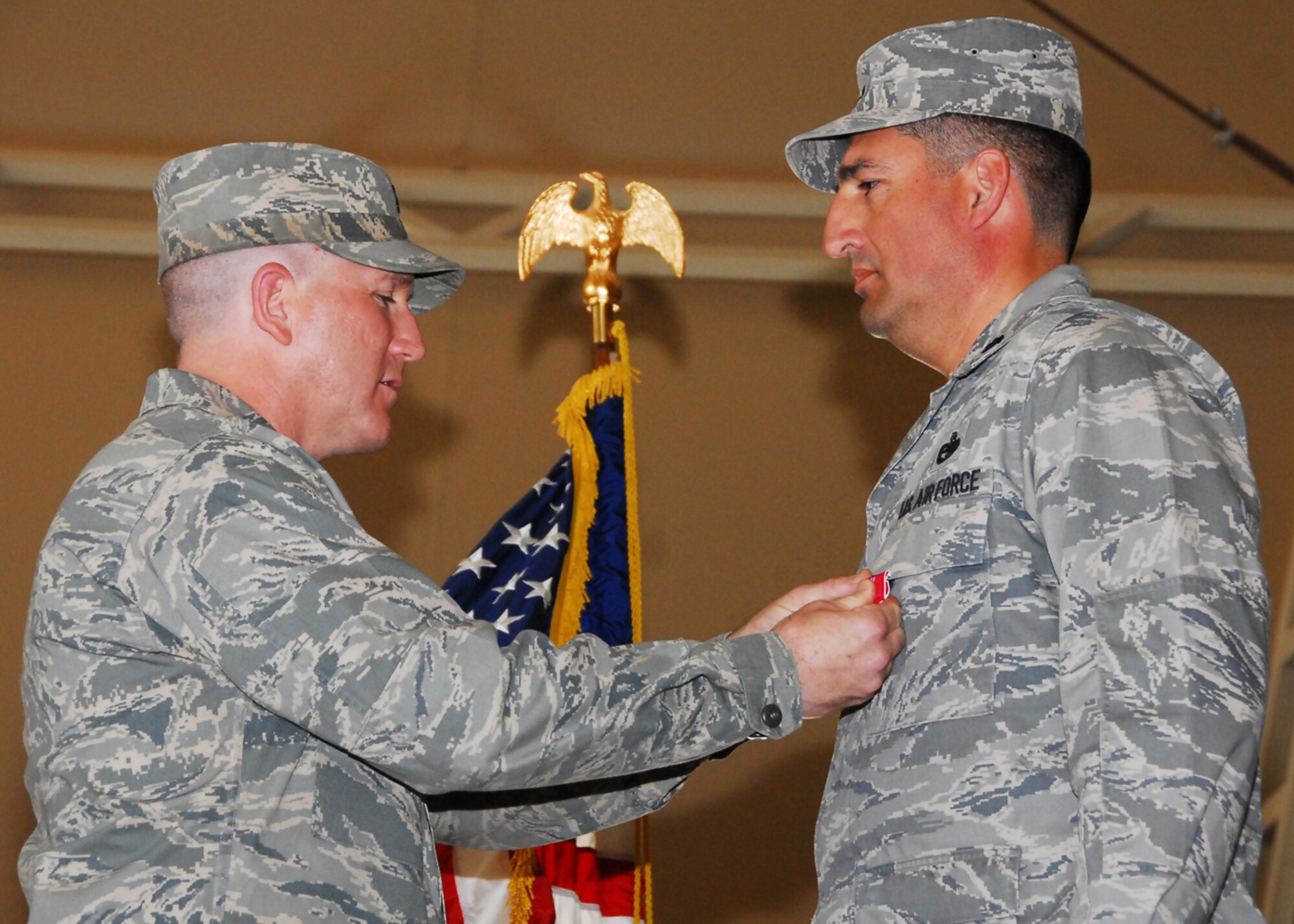 SOUTHWEST ASIA -- Lt. Col. Carlos Camarillo, 586th Expeditionary Logistics Readiness Squadron commander, is presented the Bronze Star by Col. Alan Metzler, 586th Air Expeditionary Group commander, at an Army base in Southwest Asia, March 12. Colonel Camarillo is currently deployed from Dover AFB, Del. (U.S. Air Force photo/Senior Airman Courtney Richardson)