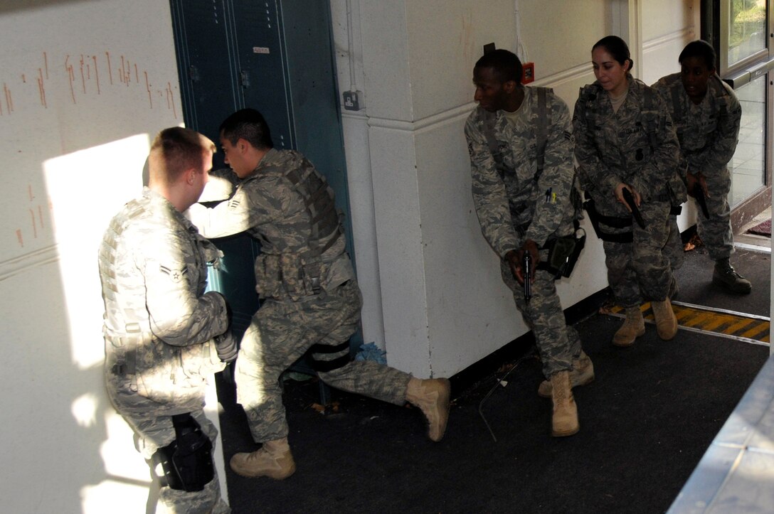 Airmen from the 48th Security Forces Squadron search each room to make sure there are no longer any more suspects or children in the school during a training exercise March 4, 2009  at RAF Feltwell, England. The Airmen are participating in an "Active Shooter" scenario which teaches security forces Airmen how to handle a school shooting. (U.S. Air Force photo by Airman 1st Class Perry Aston) 
