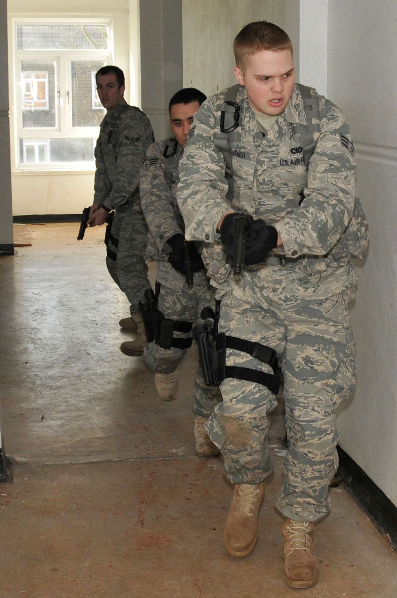 Airmen from the 48th Security Forces Squadron search each room to make sure there are no longer any more suspects or children in the school during a training exercise March 4, 2009 at RAF Feltwell, England. The Airmen are participating in an "Active Shooter" scenario which teaches security forces Airmen how to handle a school shooting. (U.S. Air Force photo by Airman 1st Class Perry Aston) 