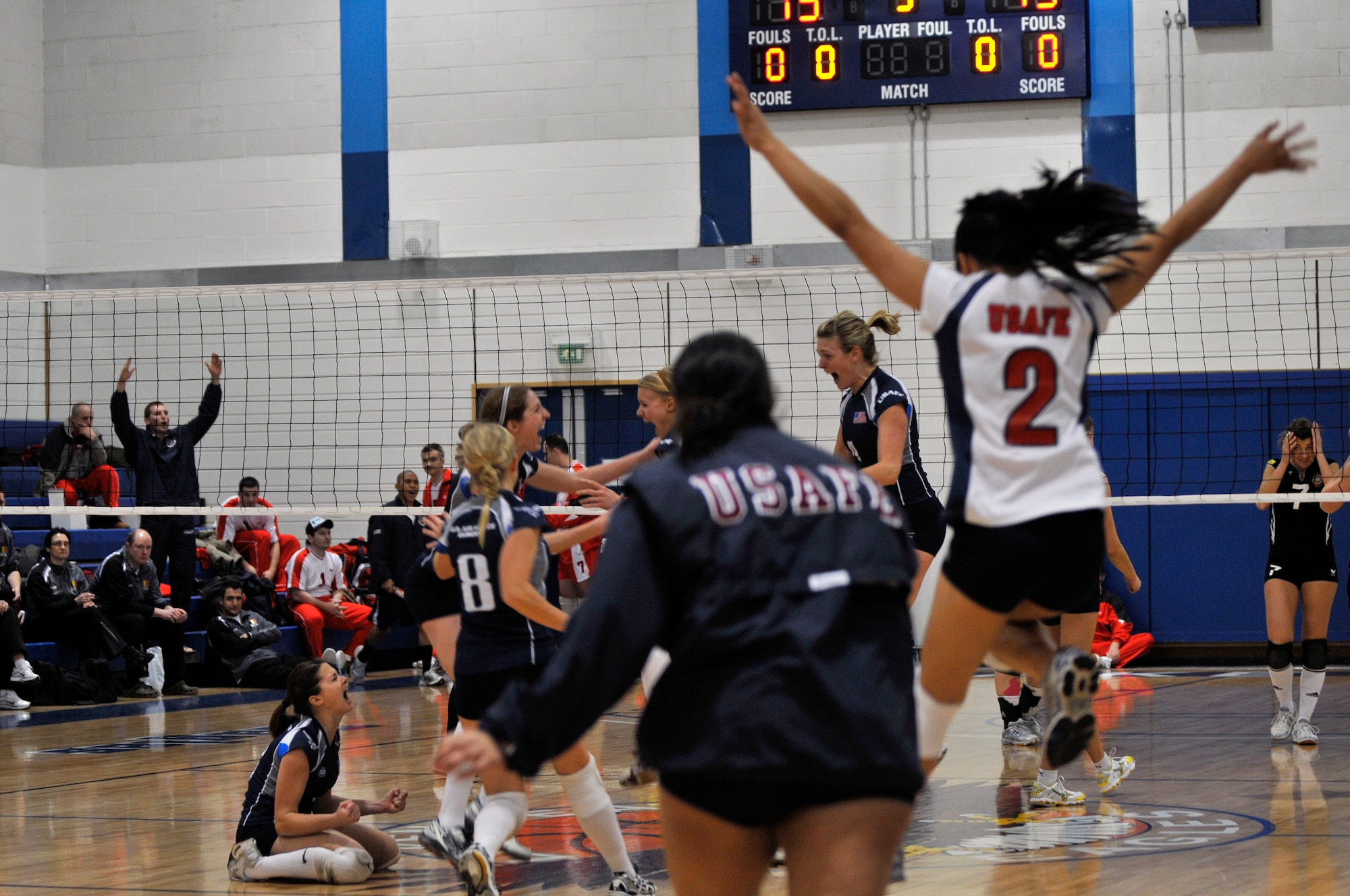 U.S. Air Forces in Europe Women’s Volleyball Team celebrate after beating the German Air Force March 11, 2009 at RAF Lakenheath, England. The Women’s finals went to five matches with USAFE winning 15 to 13 (U.S. Air Force photo by Airman 1st Class Perry Aston)