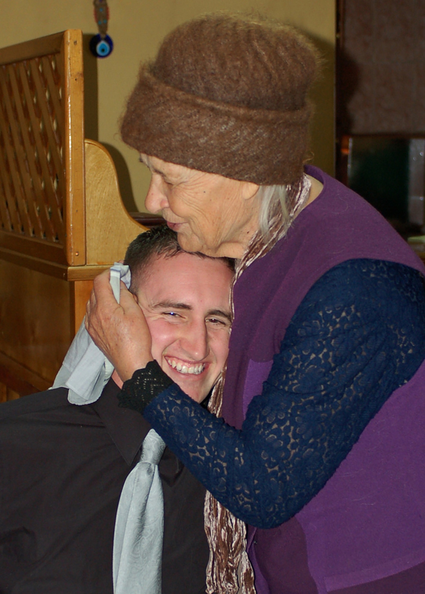 Mariya Ruhlova hugs Senior Airman Paul Cummings in a grandmotherly way during a Manas Air Base Outreach Society visit at a Turkish restaurant in Bishkek, Kygryzstan, March 9. Mariya is known as a Babushka, or elderly woman, in Russian and Kyrgyz cultures. The 79-year-old woman has no family and was ?adopted,? along with two other elderly women, by MABOS through the Babushka Adoption Foundation, a local non-governmental organization. Each lady?s monthly income averages about 700 som or around $20 per month. Every month, volunteers from Manas join the ladies for lunch to share companionship, a little financial support and a small supply of groceries. Airman Cummings is assigned to the 376th Expeditionary Medical Group and is deployed from the 81st Medical Group at Keesler Air Force Base, Miss. (U.S. Air Force photo/Tech. Sgt. Elizabeth Weinberg)