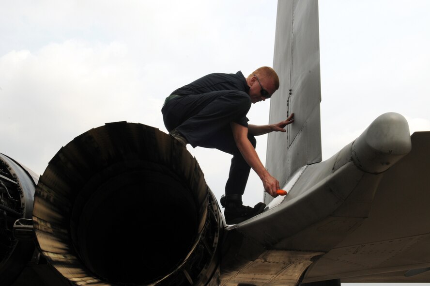 U.S. Air Force Senior Airman Collin Urbanowicz, from the 18th Aircraft Maintenance Squadron, Kadena Air Base, Japan, works with a Thai aircraft refueler to refuel one of Kadena's F-15's on the flight line at Korat Royal Air Force Base, Thailand during Cope Tiger 2009 on March 10.Cope Tiger 2009 is an annual exercise to improve combat readiness and combined and joint interoperability of U.S., Thai and Singaporean forces while enhancing regional security and providing humanitarian support.(U.S. Air Force Photo/Staff Sgt. Angelique Perez) 