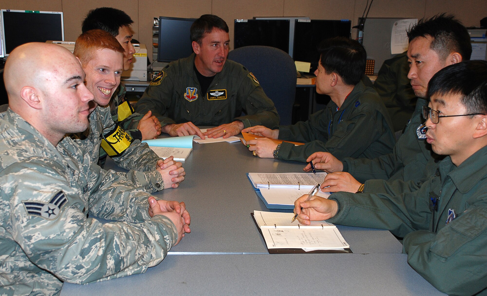 OSAN AIR BASE, Republic of Korea --  (Left to right) Senior Airman Zachary Shook, Staff Sgt. Michael Cevette, Capt. Mu Jin Kim and Lt. Col. James Johnson discuss roles of “White Cell” members with Republic of Korea officers Lt. Col. Ryu, Kilsap, Lt. Col. Kim, Sangho, and Maj. Park, Chan Yeop during the Key Resolve/Foal Eagle exercise here March 9. KR/FE, like all Combined Forces Command (CFC) exercises, is defense-oriented and designed to enhance readiness and the ability of the ROK-U.S. Alliance to defend the ROK against external aggression. (U.S. Air Force photo by Staff Sgt. Alexy Saltekoff)