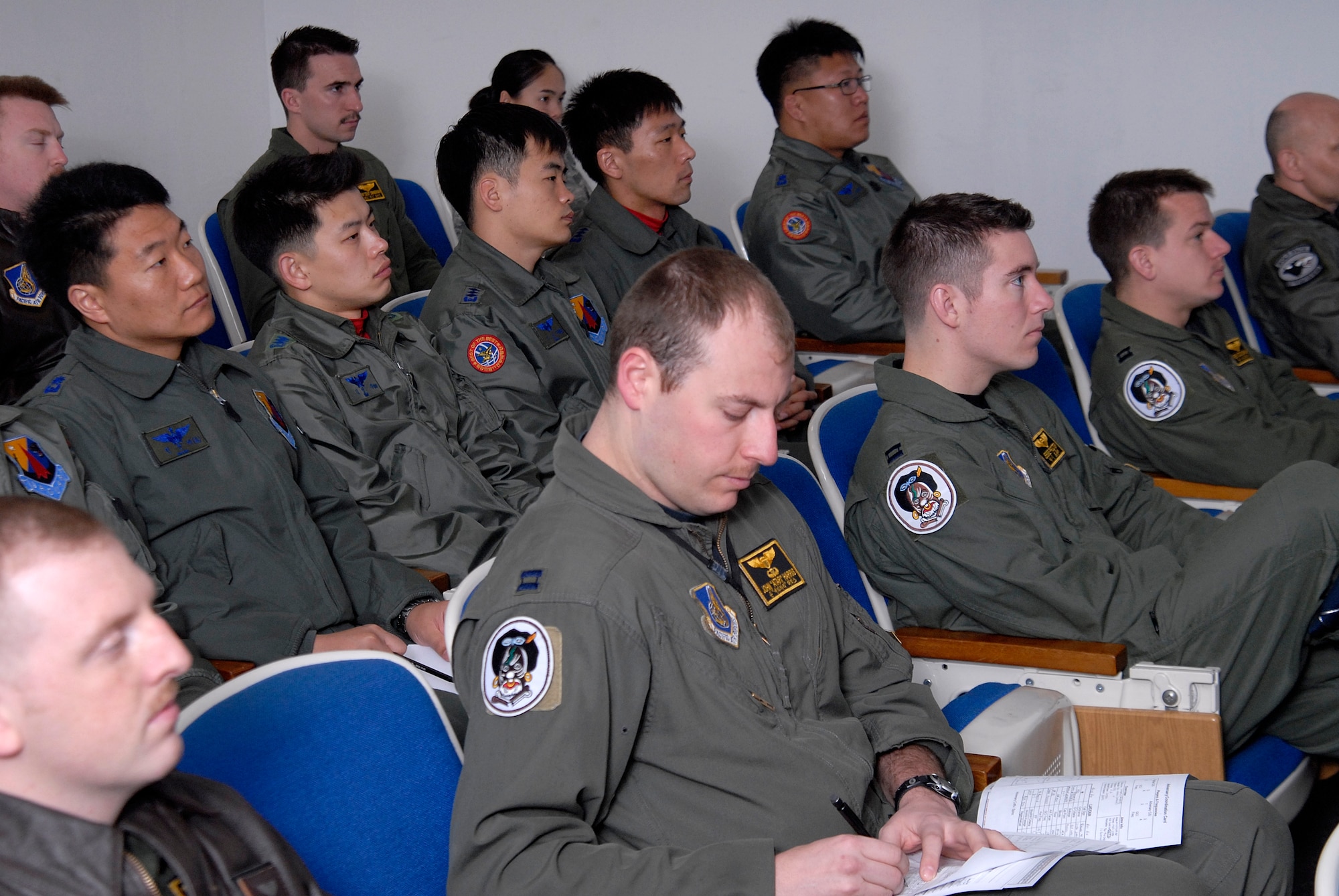 Airmen from the Republic of Korea Air Force's 11th Tactical Fighter Wing out of Daegu Air Base, sit in on a mass flight briefing with members of the 80th Fighter Squadron at Kunsan Air Base, Republic of Korea, March 10, 2009. The ROKAF pilots are here in support of the Buddy Wing program, an operation designed to increase U.S. Air Force and ROKAF interoperability. (U.S. Air Force Photo by SSgt Jason Colbert)