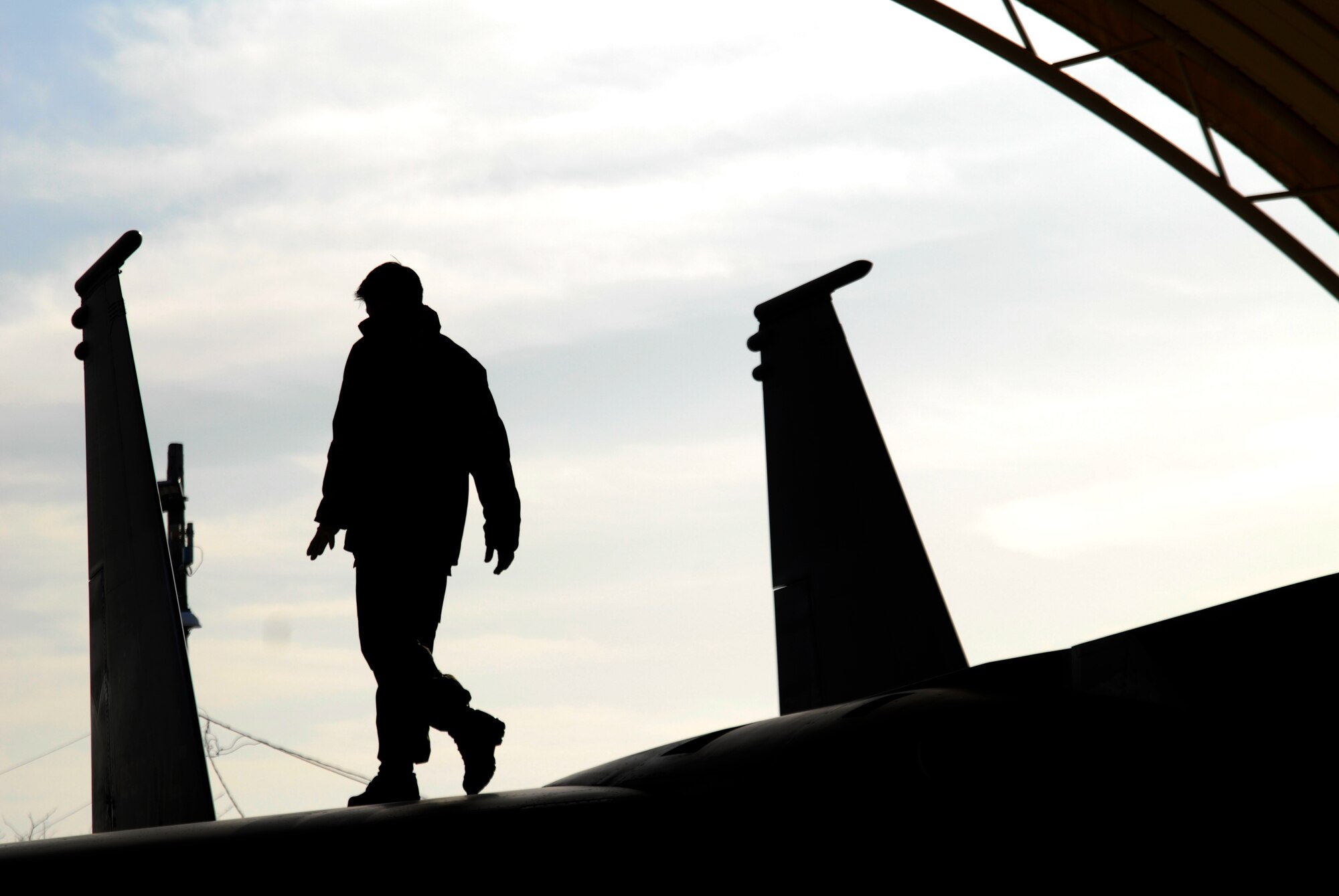 A maintainer from the Republic of Korea Air Force's 11th Tactical Fighter Wing out of Daegu Air Base, walks on top of a F-15K Slam Eagle checking for damage at Kunsan Air Base, Republic of Korea, March 10, 2009. The ROKAF pilots and maintainers are here in support of the Buddy Wing program, an operation designed to increase United States Air Force and ROKAF interoperability. (U.S. Air Force Photo by SSgt Jason Colbert)