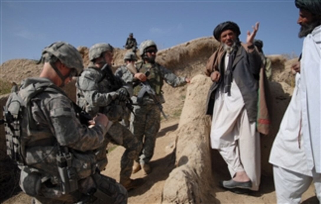 U.S. Army 1st Lt. Jared Tomberlin (2nd from left) speaks with village elders during a key leader engagement in a town near Forward Operating Base Lane in the Zabul province of Afghanistan on March 5, 2009.  Tomberlin is assigned to Bravo Company, 1st Battalion, 4th Infantry Regiment.  