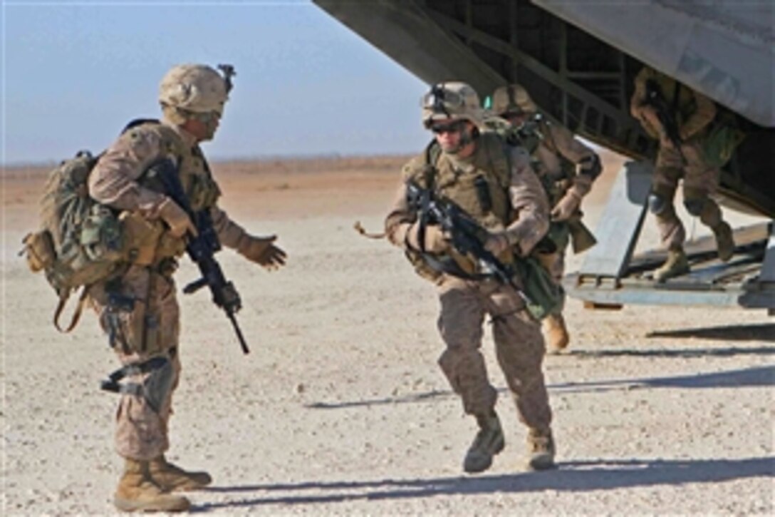 U.S. Marines exit a CH-53 helicopter during an exercise on Camp Ripper, Iraq, March 11, 2009. The Marines are part of a quick reaction force composed of Marines assigned to Bravo Company, 1st Tanks Battalion, Regimental Combat Team 8.