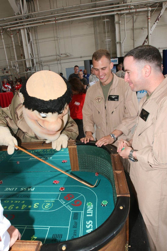 The San Diego Padres mascot Friar John plays a game of craps with Marines during the welcome home party inside Hangar 1 aboard Marine Corps Air Station Miramar, March 13. Throughout the afternoon, Marines and sailors played poker, shook hands with celebrities and listened to live music. (U.S. Marine Corps photo by Lance Cpl. Christopher O'Quin) (Released)