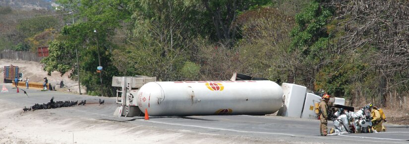 SOTO CANO AIR BASE, Honduras - Firefighters from Comayagua and Joint Task Force-Bravo set up a water hose to cool an overturned fuel tanker on C.A. 5 approximately 8 kilometers north of the base Friday.  The tanker overturned after hitting a horse around 8 a.m. and caused traffic to be halted in both directions for more than 24 hours.  (U.S. Air Force photo/Tech. Sgt. Rebecca Danét)